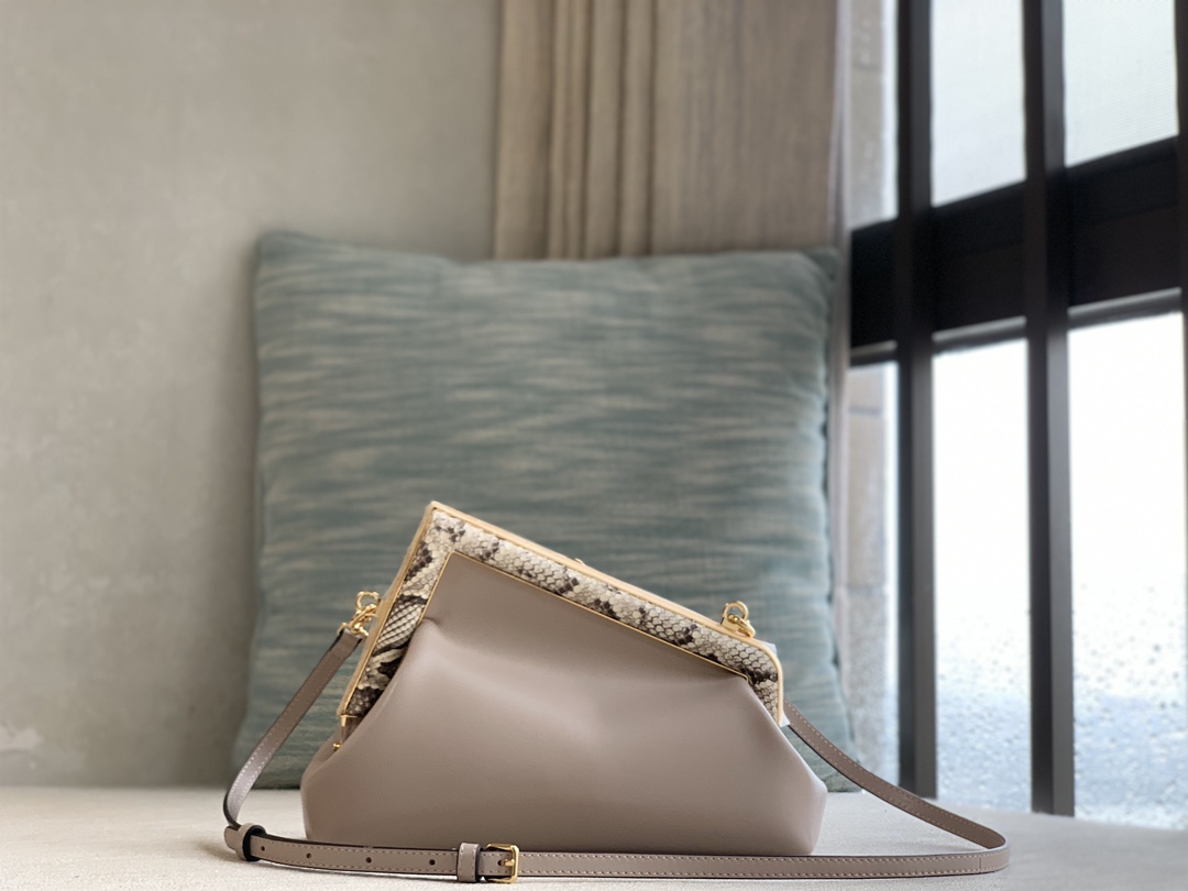 Fendi First series small series, made of lambskin, decorated with an oversized F metal buckle, and covered with luxurious python skin of the same