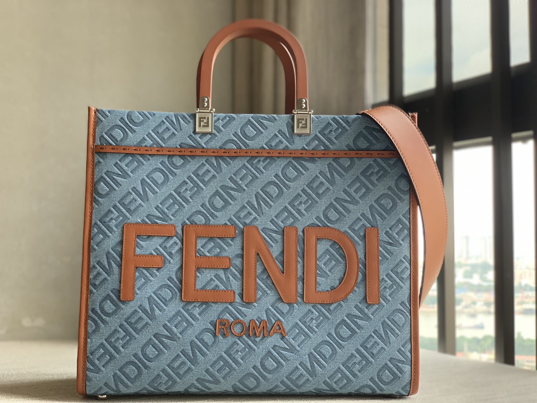 fendi Sunshine medium shopper bag in light blue denim with FENDI Mirror pattern all over. Brown solid leather handle with FENDI ROMA signature. F