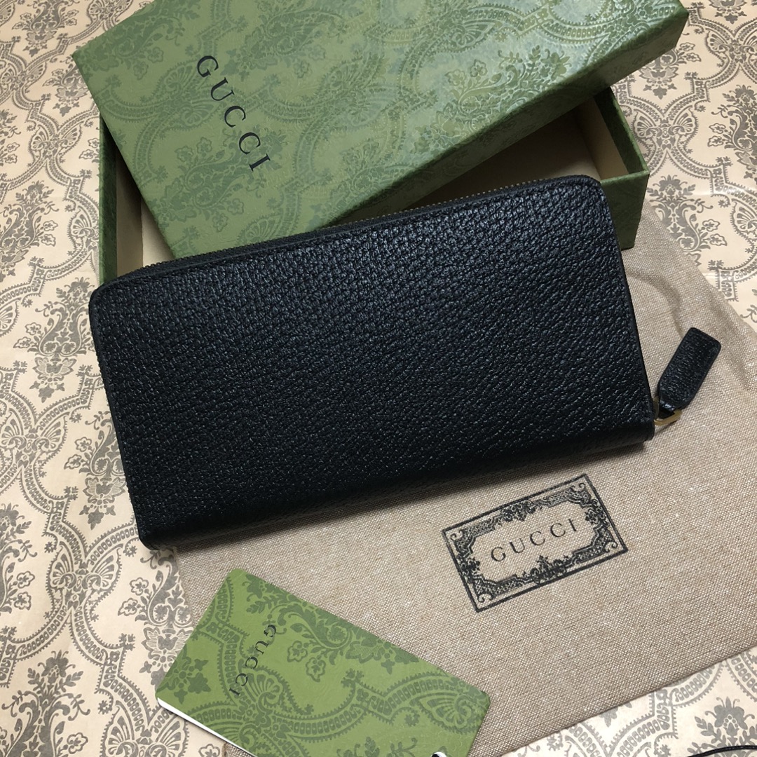 此款全拉链式钱包，配以醒目的标志性双 G 金属配件。采用热压小牛皮制作，以获得野猪猪皮效果，营造织纹外观