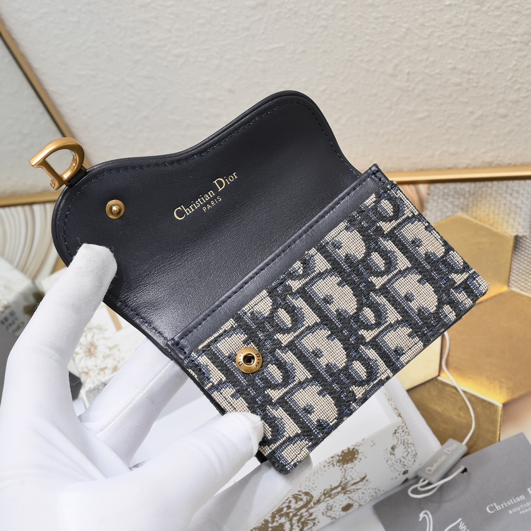 Dior ObliqueSaddle零钱包非常有辨识度的马鞍形状已经成为了D家的代表性元素外面的盖子是一个手枪造型标志性的字母D作装饰如今小包当道摆脱大钱包换上一个小巧 的卡包/零钱包就妥妥当当啦~