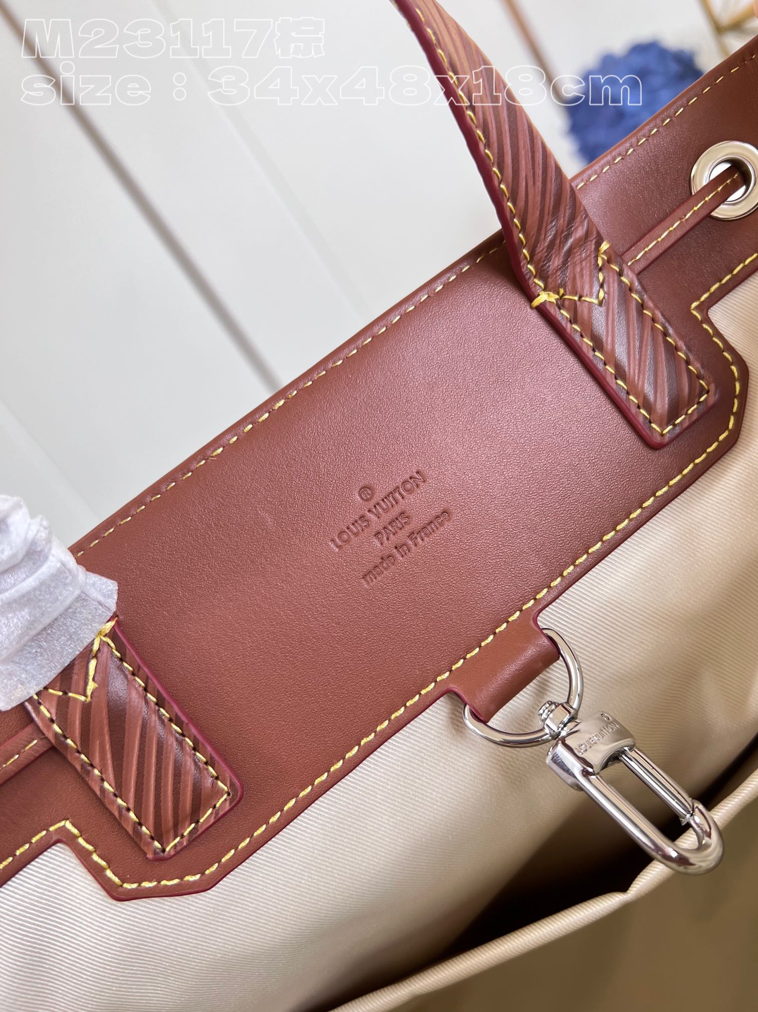 The bag features a spacious interior secured with a drawstring closure - Bag 9