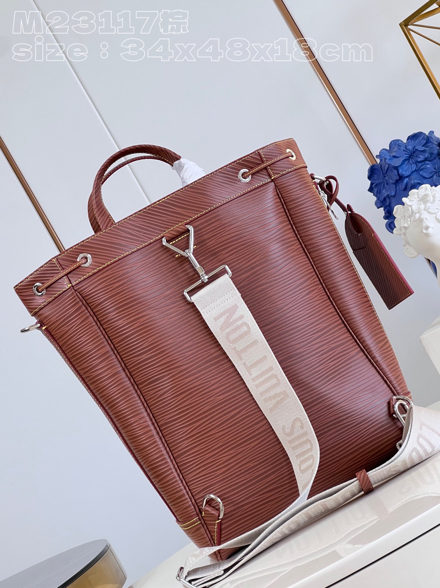 The bag features a spacious interior secured with a drawstring closure - Bag 6
