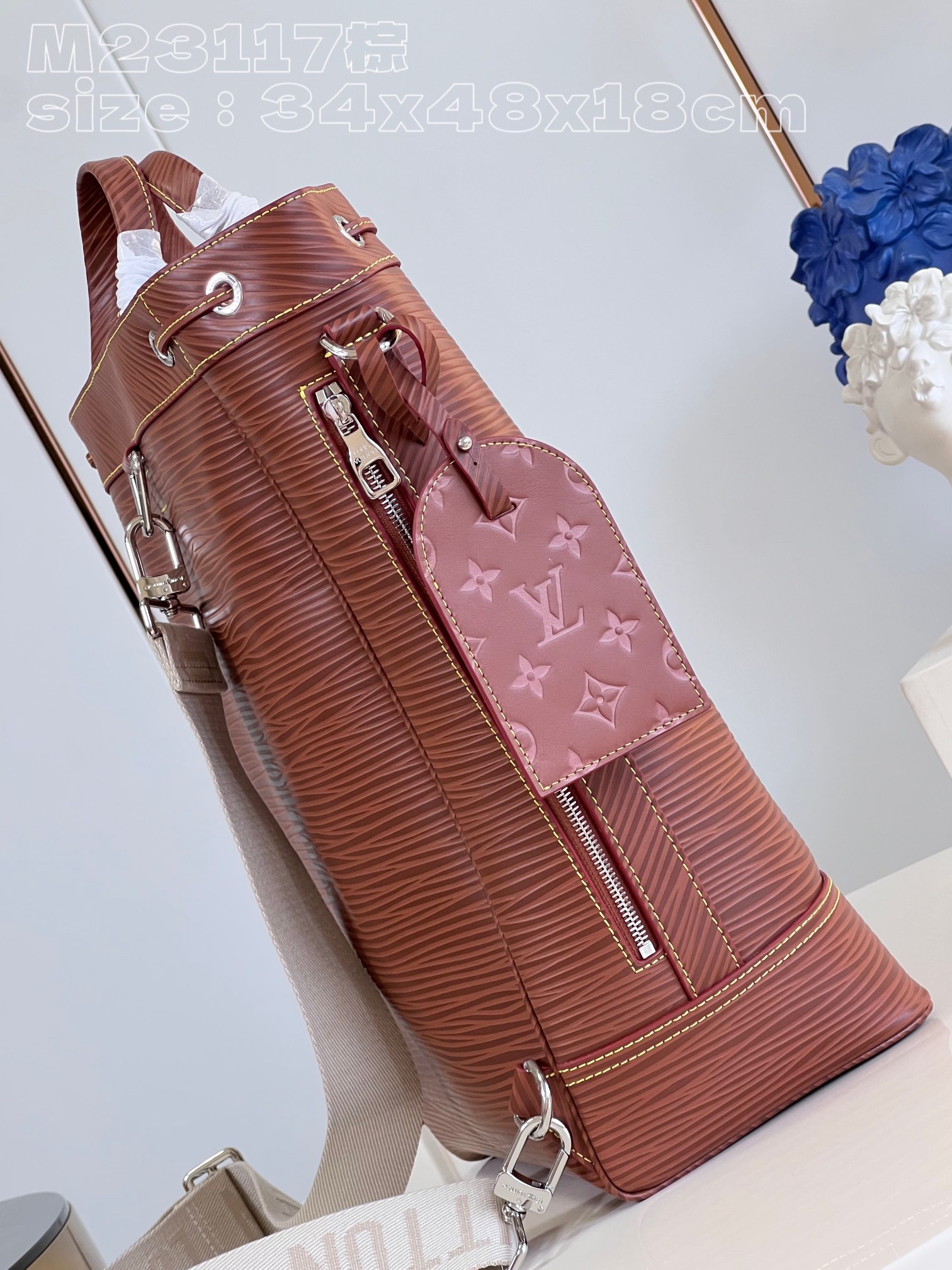 The bag features a spacious interior secured with a drawstring closure - Bag 4