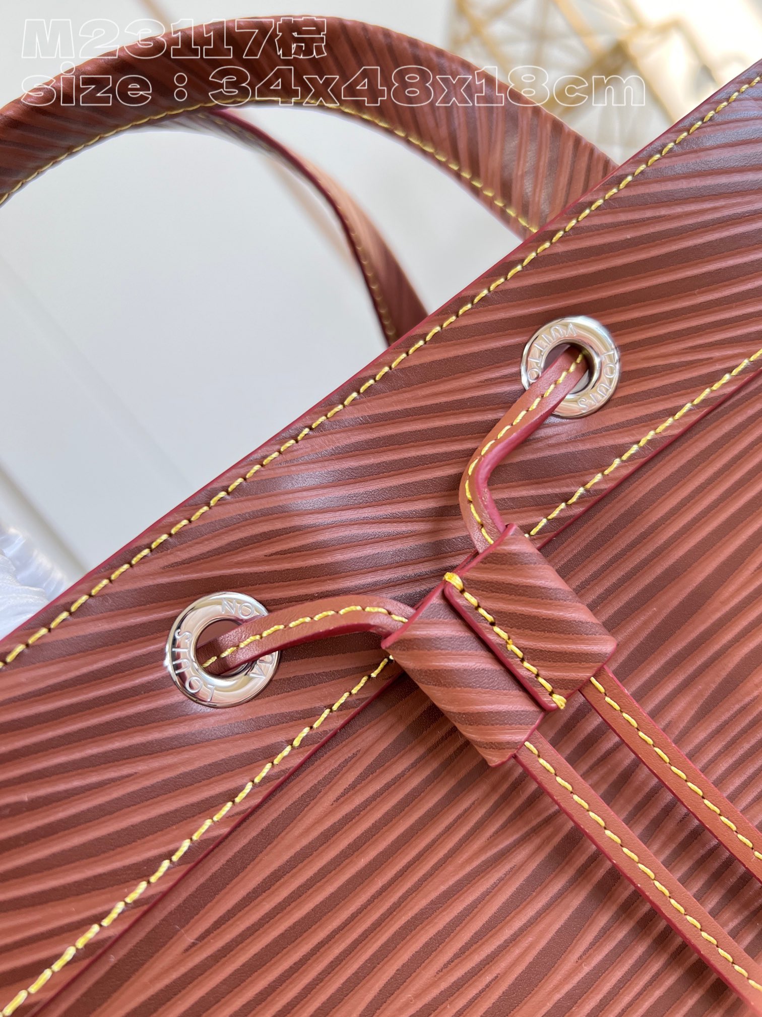 The bag features a spacious interior secured with a drawstring closure - Bag 3