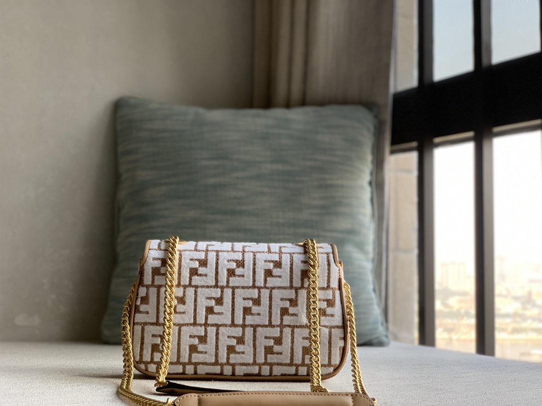 Fendi's signature medium Baguette with chain tote, woven in original raffia and embroidered with a brocade-effect chenille FF pattern for a uniqu