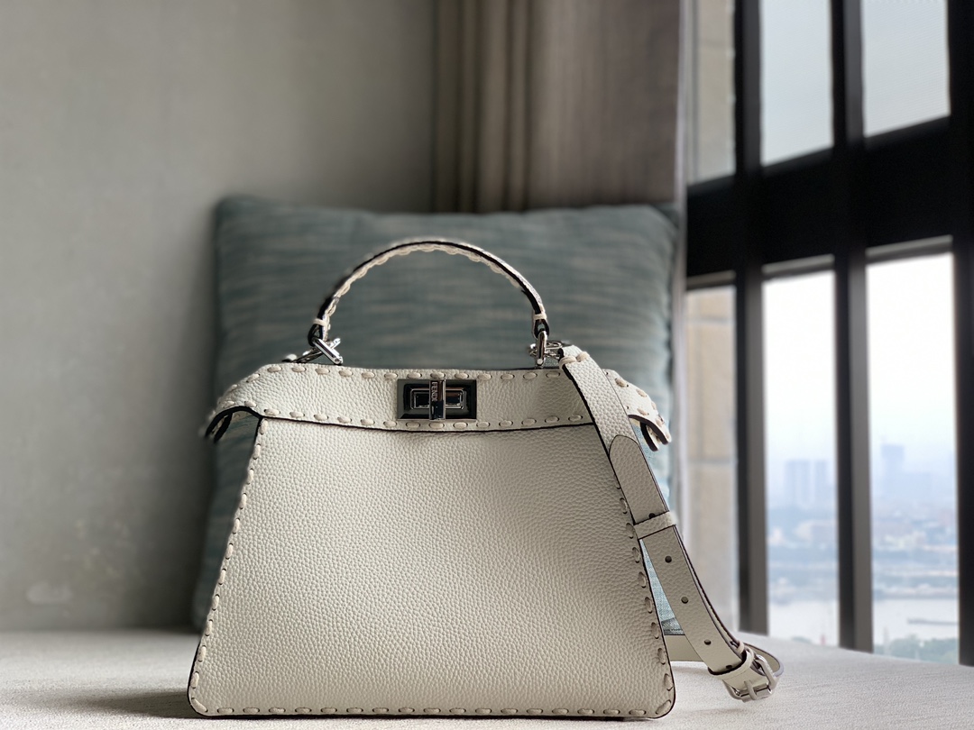 Fendi's signature Peekaboo ISeeU small handbag, made of Cuoio Romano calfskin, decorated with tonal hand-stitching and classic twist locks on bot