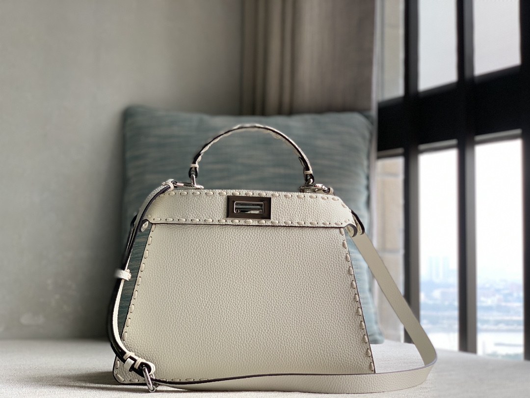 Fendi's signature Peekaboo ISeeU small handbag, made of Cuoio Romano calfskin, decorated with tonal hand-stitching and classic twist locks on bot