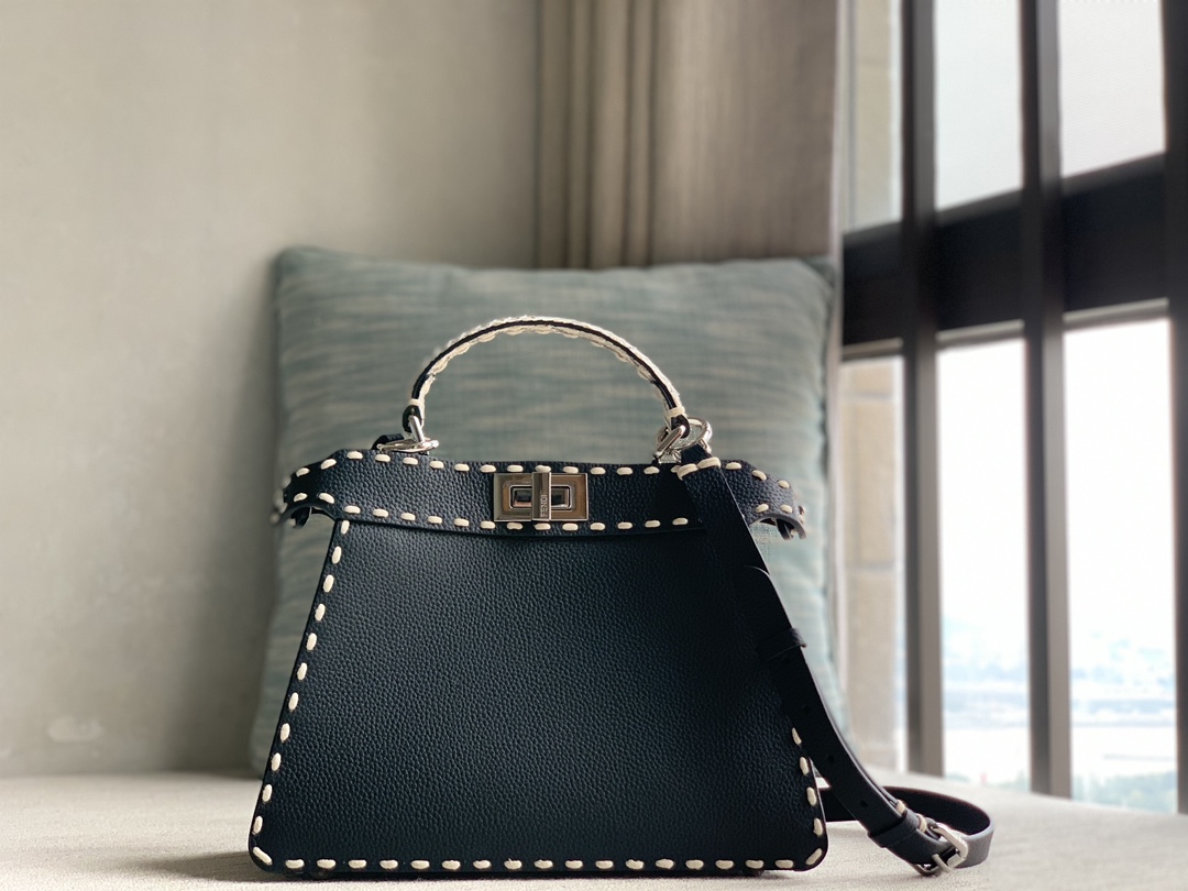 Fendi's iconic Peekaboo ISeeU small handbag, made of Cuoio Romano leather, decorated with hand-stitching in the same color and classic twist lock