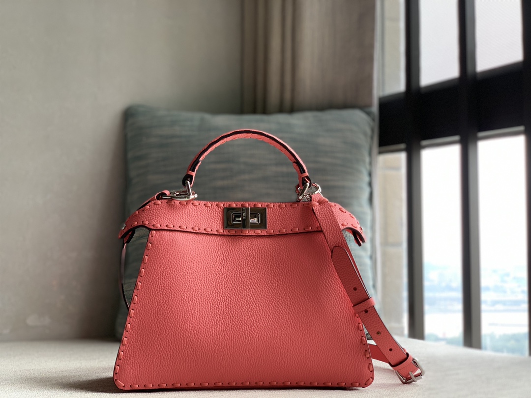 Fendi's iconic pure original Peekaboo ISeeU small handbag, made of pink Cuoio Romano leather, decorated with hand-stitching of the same color, wi