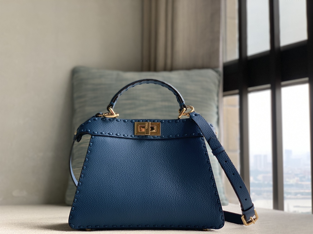 Fendi's iconic Peekaboo ISeeU small handbag in pure raw calfskin, made of blue Cuoio Romano leather, decorated with hand-stitching of the same co