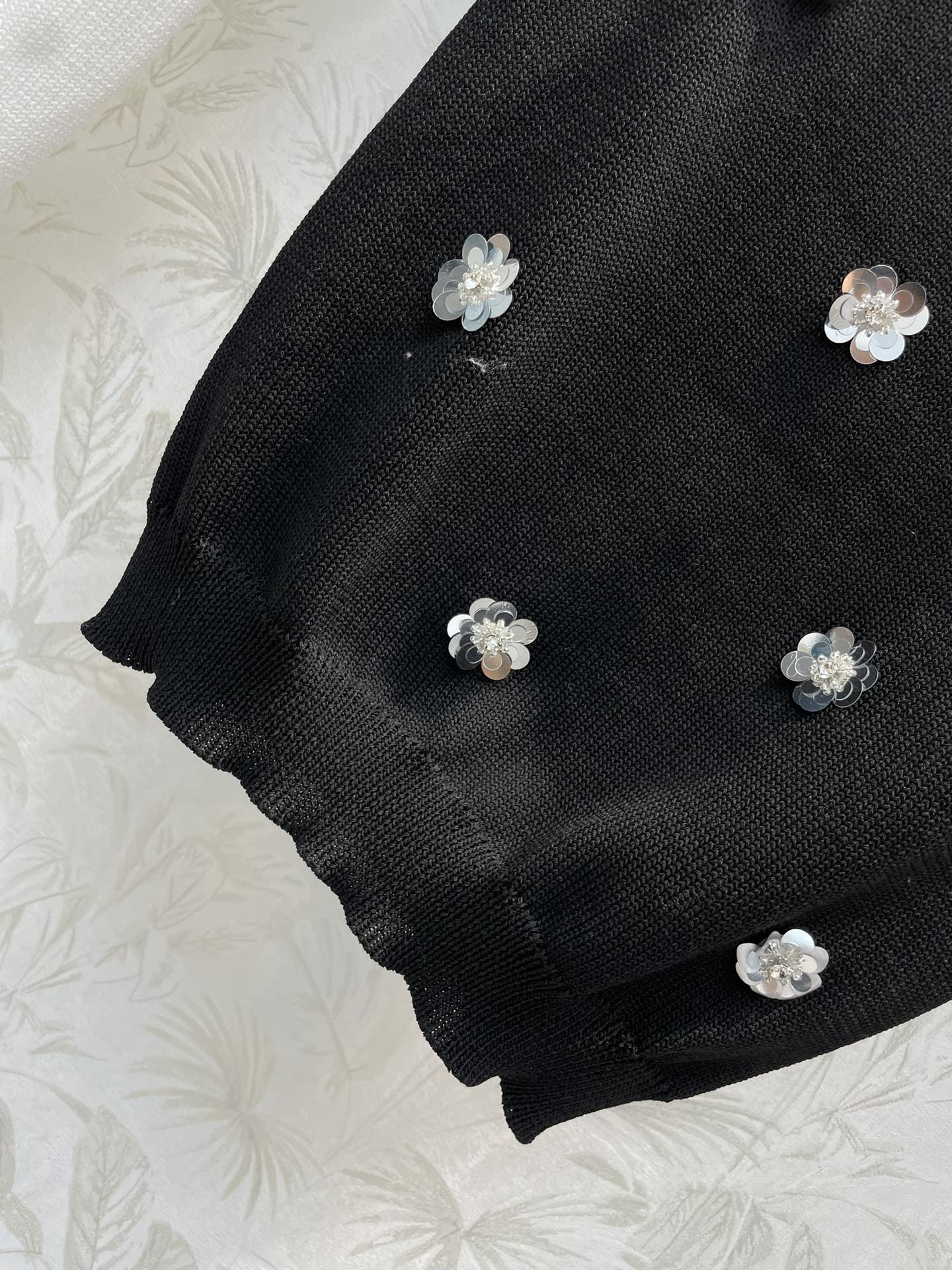 Miu家24新款重工艺钉珠花朵针织背心经典的黑白款搭配修身的短款版型胸前是重工的钉珠花朵贴布装饰logo