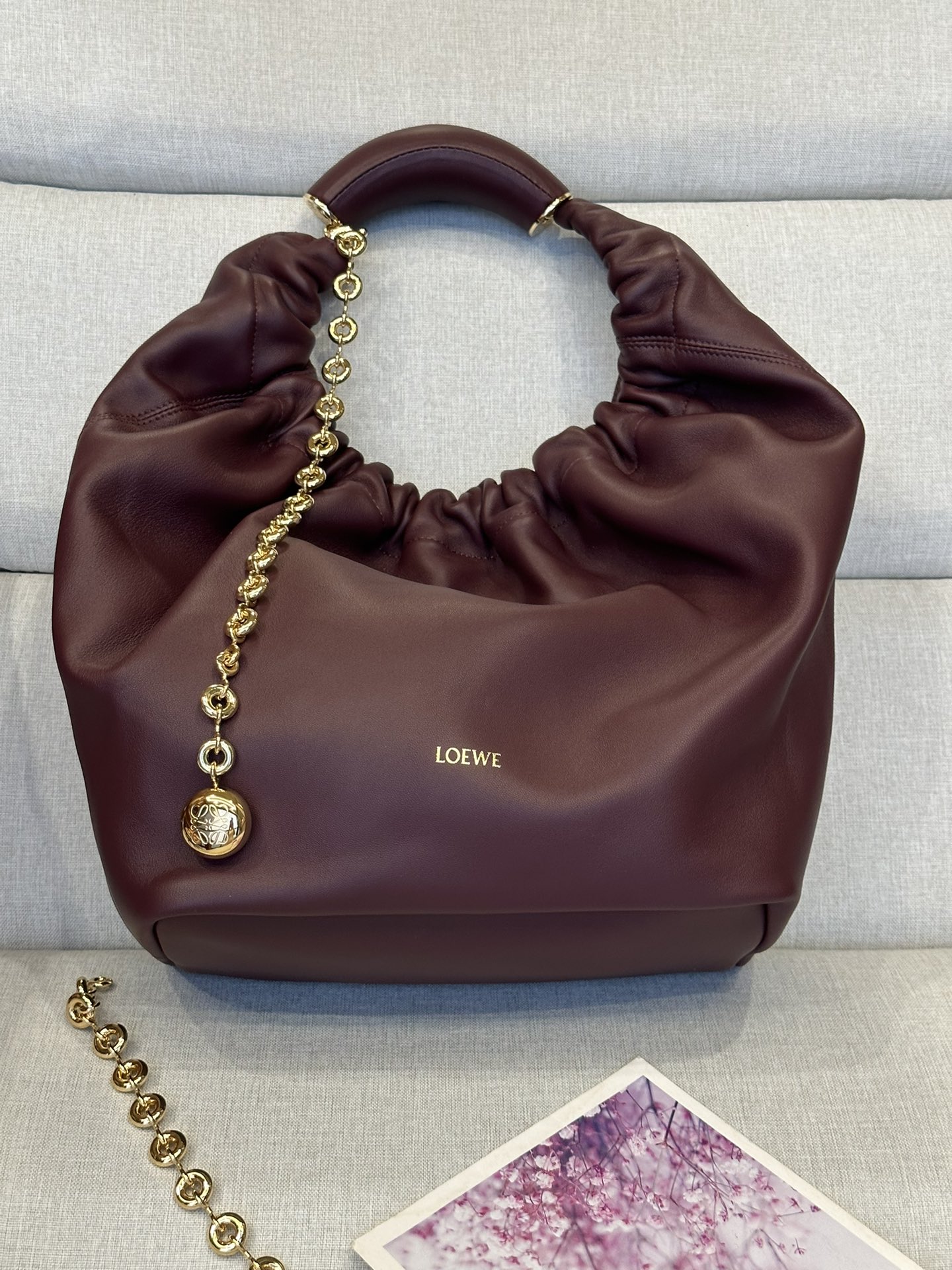 NO:179447,LOw Medium 3902 Napa Sheepskin Squeeze Handbag A new exquisite and soft handbag made of soft-touch Napa leather. This craft is a masterpiece of traditional craftsmanship, innovative research and unique design, with a surprisingly lightweight pleated body, adjustable donut chain and soft-touch handle. This medium version is made of Napa Sheepskin.* shoulder-mounted, cross-body or hand-held* adjustable chain straps, paired with Anagram carved pebbles, additional chains for further extensions* magnetic buckle closure* internal zipper pocket* unlined*lo*ewe gold or silver hot. size34*13.5*33CM, special Loewe, sheepskin19860909LOw中号 3902 纳帕羊皮Squeeze手袋一款精致而柔美的全新手袋,采用触感柔软的纳帕皮革制成.这款顺手艺是传统工艺、创新研究和独特设计的杰作,具备令人惊讶的轻盈褶皱包身、可调节甜甜圈链条和触感柔软的提手.此中号版本采用纳帕羊皮革打造.*可肩背、斜挎或手提*可调节链条肩带,搭配Anagram携刻鹅卵石,附加额外链条,可进一步延长肩带*磁扣开合*内部拉链口袋*无衬里*lo*ewe烫金或烫银. size34*13.5*33CM,特级罗意威,loewe,sheepskin,Bag