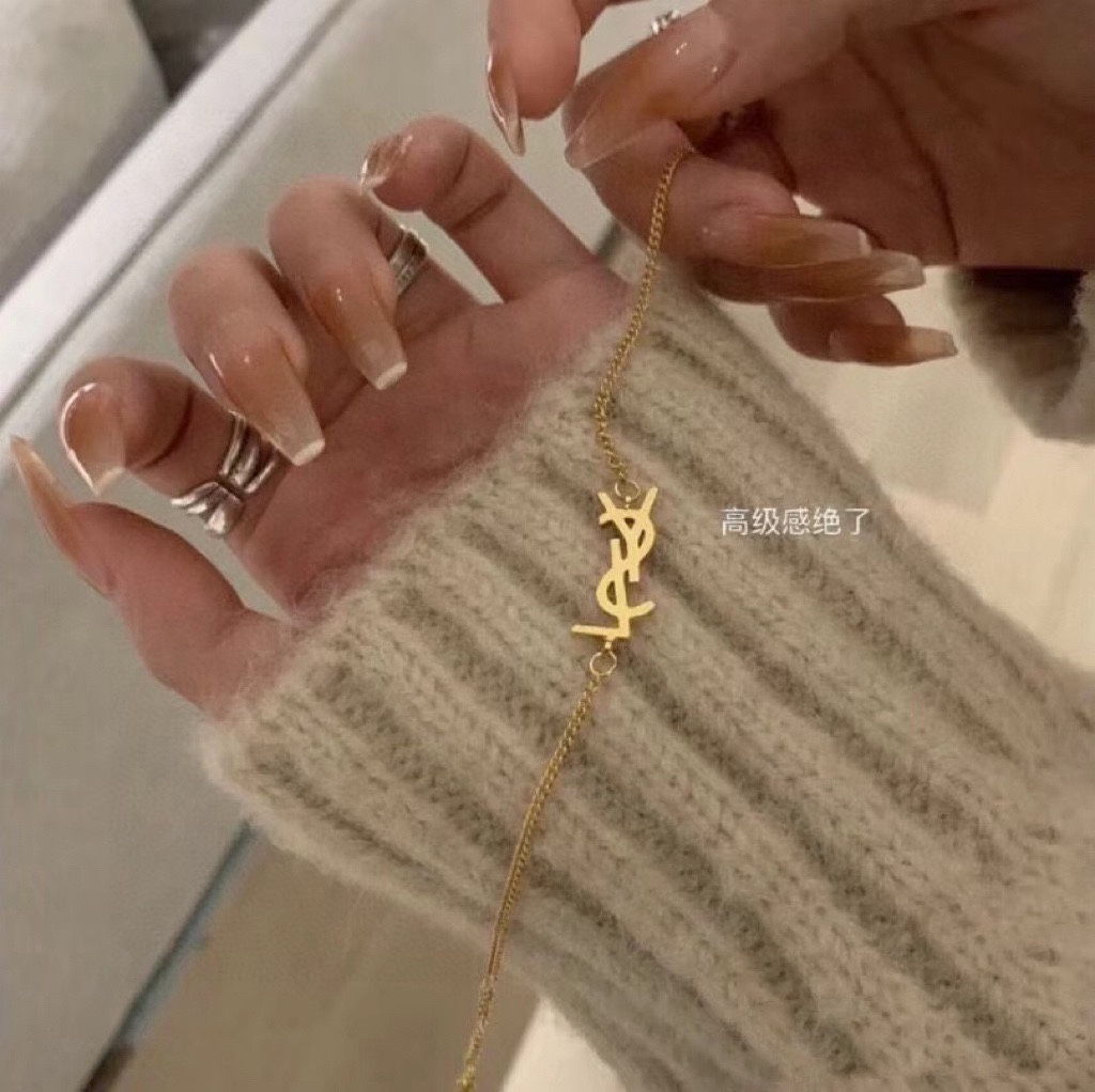 Title: YSL St. Roland Bracelet: Elegant French Luxury Fashion Since 1961 Summary: YSL’s St. Roland bracelet, a luxury fashion icon since 1961, features elegant