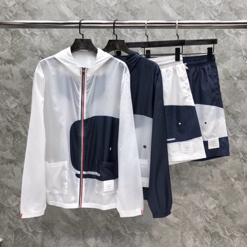 Title: THOM BROWNE Whale Sunscreen Jackets Description Summary: THOM BROWNE offers TB-B whale sunscreen jackets in white and blue colors with code numbers for sizing.