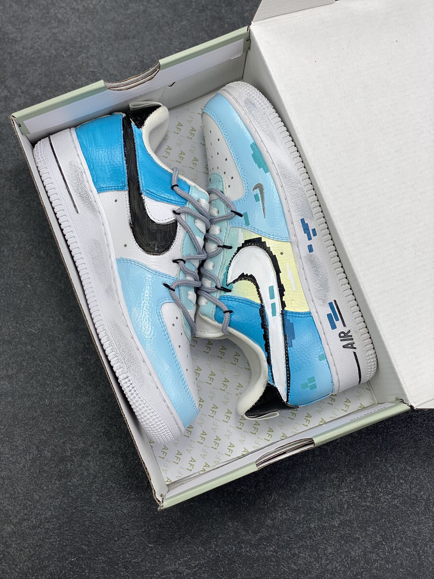 图片[9]-Nike Air Force 1\’07 Low 手绘涂鸦 电玩蓝调 空军一号低帮休闲板鞋  #鞋身主调是清新又富有层次的蓝调–浅蓝如晴空初绽，湖蓝似像素方块的跃动，在纯白中底的衬托下，既带着复古游戏的像素颗粒感，又透出潮流圈稀缺的清新质感。标志性的Swoosh被像素化解构，鞋侧、中底的方块元素像是从复古电玩画面中“抠”出的符号，每一处细节都在唤醒玩家对像素游戏的怀旧共鸣 货号：FB8917-300  尺码：36 36.5 37.5 38 38.5 39 40 40.5 41 42 42.5 43 44 44.5 45-选品中心