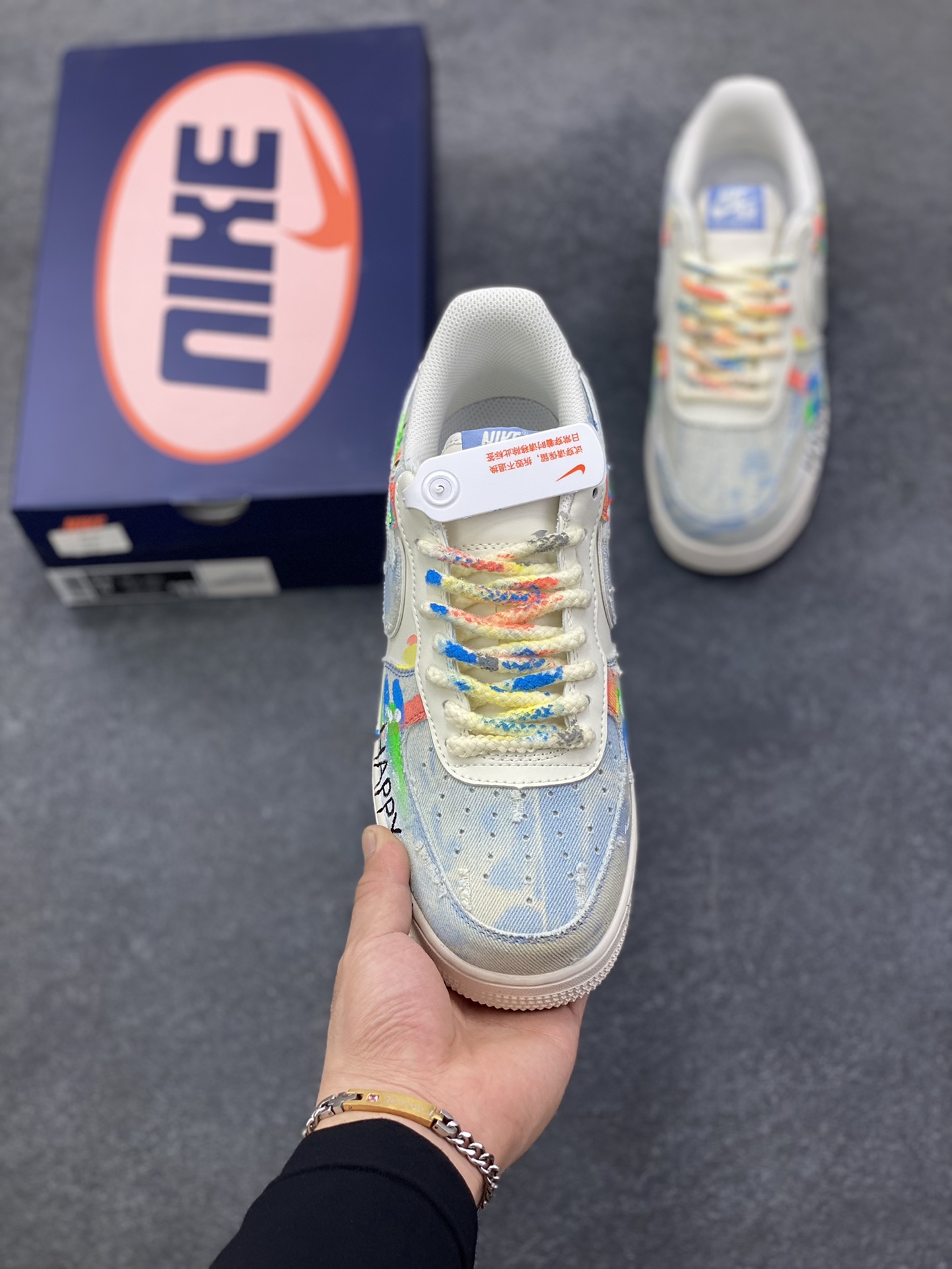 图片[2]-手绘涂鸦“狂想牛仔”Nike Air Force 1 “Fantasy Cowboy”空军一号定制板鞋 这双鞋以米白基底碰撞水洗牛仔面料，破洞与毛边的细节为复古质感注入随性基因。彩色泼墨、“HAPPY”“So……”的手写涂鸦，像是创作者在鞋面上的情绪速写，将快乐与戏谑的灵魂具象化；带彩点的鞋带、鞋侧标志性Swoosh的牛仔拼接，每一处设计都在打破常规，把街头艺术的野性与牛仔的复古肌理揉成独特的潮流语言 货号：CW1888-116 尺码：36 36.5 37.5 38 38.5 39 40 40.5 41 42 42.5 43 44 44.5 45-选品中心