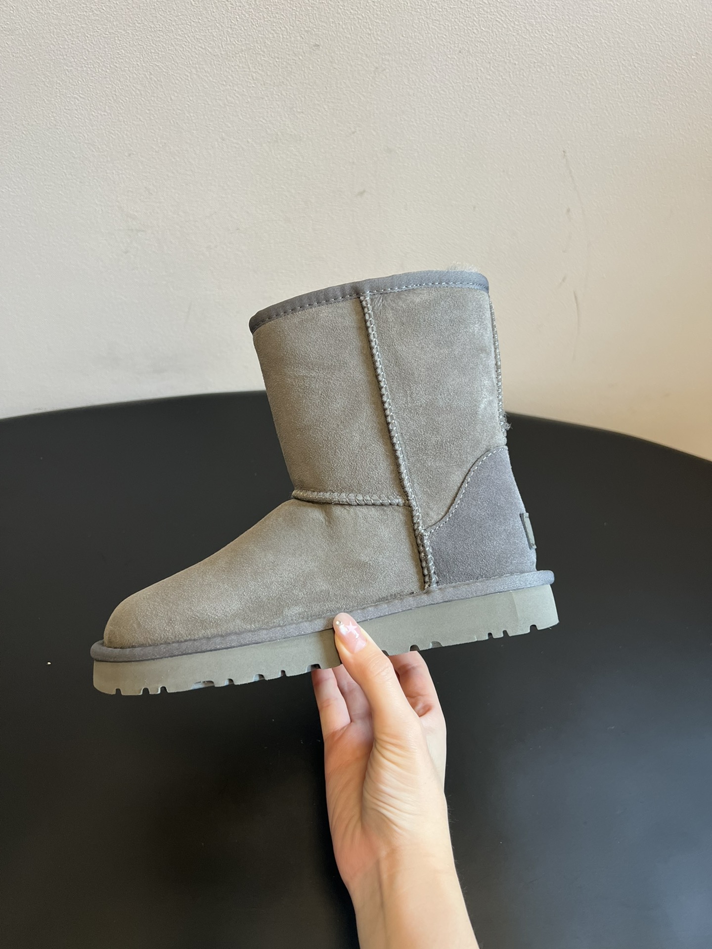 UG* 秋冬保暖圆头雪地靴鞋面采用翻毛皮材质，内里填充羊毛，实现保暖与质感的结合。中筒靴型搭配侧边扣带设