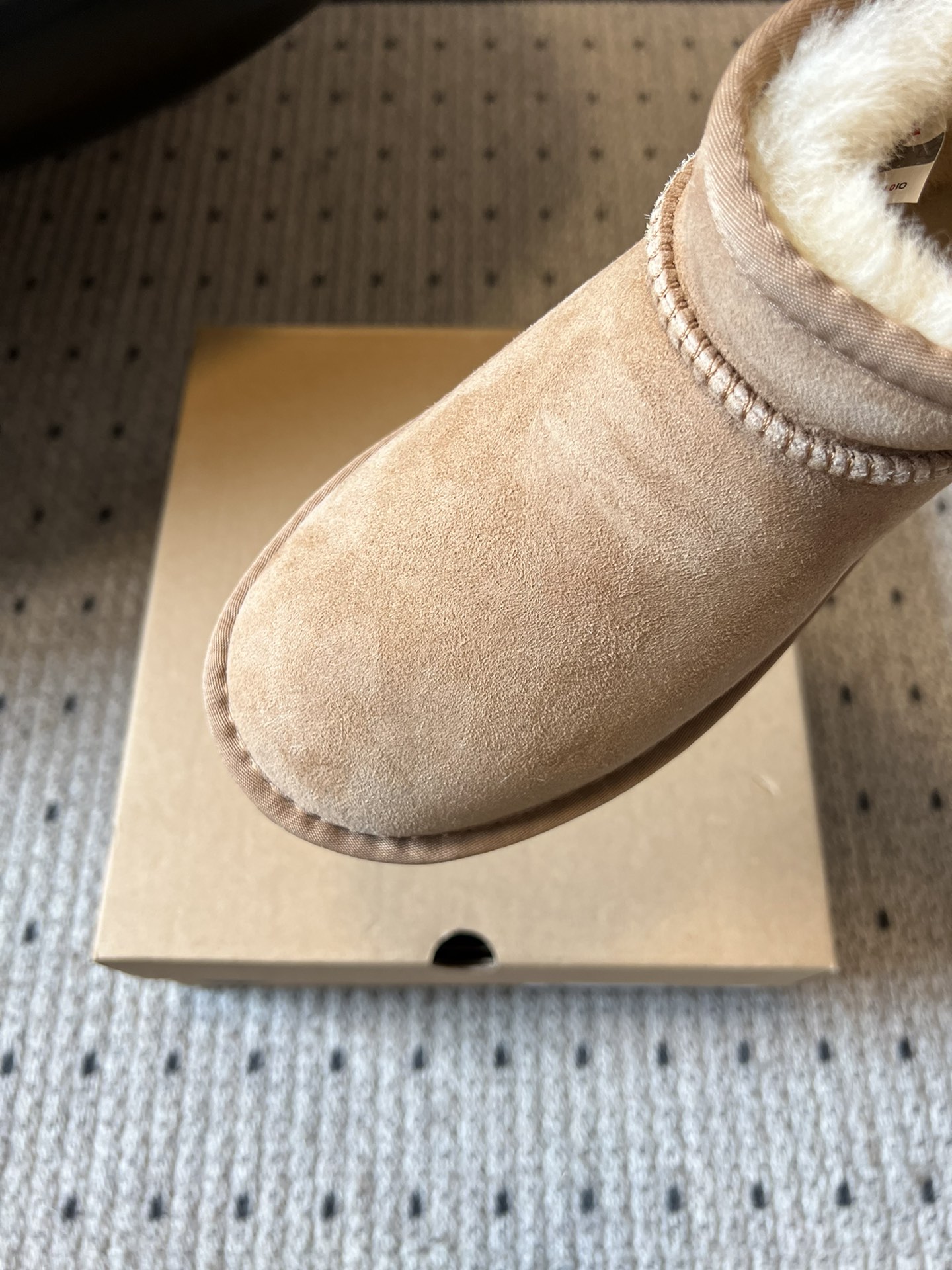 UG* 秋冬保暖mini款雪地靴采用羊皮毛一体材质，鞋面是质感细腻的反绒皮，内里填充柔软的羊毛，既保暖又