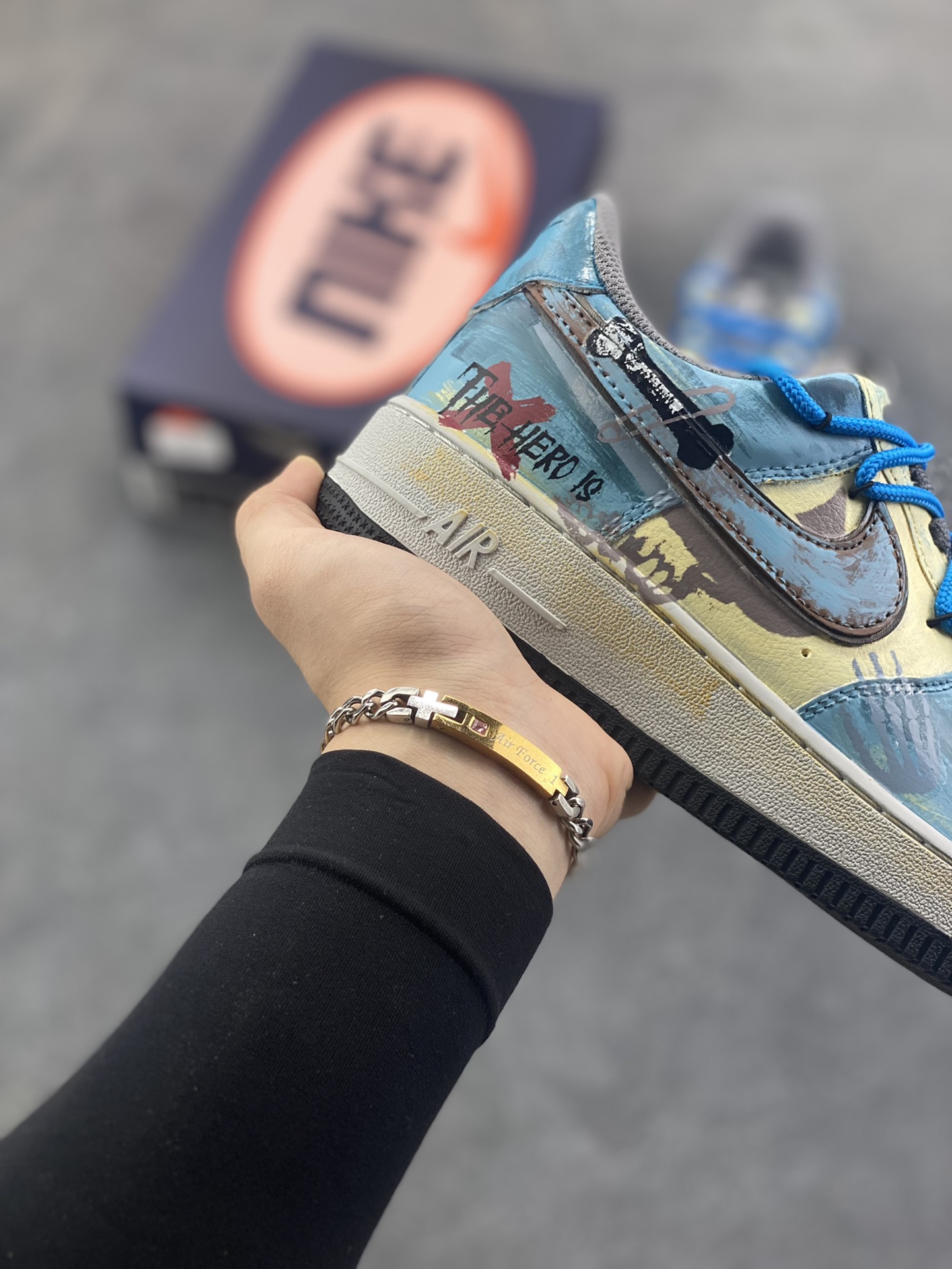 图片[6]-手绘涂鸦“雾蓝英雄”Nike Air Force 1 “Mist Blue Hero”空军一号定制板鞋 鞋身裹着一层雾感蓝灰的晕染，像清晨街景被薄雾浸软的色调，做旧肌理里藏着随性的泼墨痕迹，自带慵懒的复古滤镜；亮眼的蓝色绳状鞋带是点睛之笔，软乎乎的绳结打破了鞋身的朦胧感，添了几分街头的跳脱劲儿。鞋侧的“THE HERO”涂鸦最是灵魂——手写字体混着随性的线条，像某个少年在旧墙面上随手写下的英雄梦 货号：ZG0088-228 尺码：36 36.5 37.5 38 38.5 39 40 40.5 41 42 42.5 43 44 44.5 45-选品中心