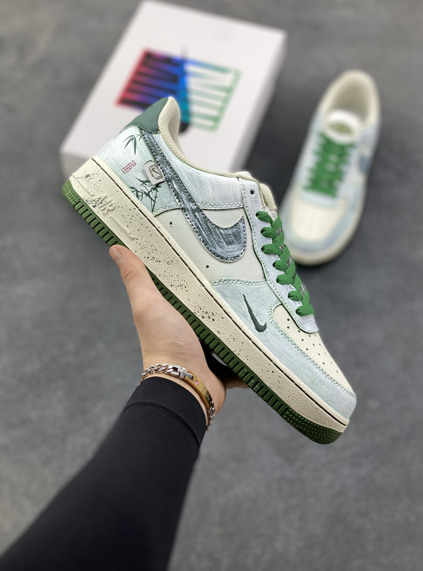手绘涂鸦“青竹墨韵”Nike Air Force 1 “Bamboo in Ink Wash”空军一号定制板鞋 这双「青竹墨韵」便成了东方美学的行走载体。鞋身以浅青瓷色为底，晕染开水墨质感的竹枝纹理 ——Logo 被竹叶肌理包裹，鞋侧的竹影细节与墨色斑点呼应，搭配深竹绿鞋带与包边，恰似烟雨里的竹林意境,让街头鞋款晕染出 “宁可食无肉，不可居无竹” 的文人风骨 货号：FB1839-123 尺码： 36 36.5 37.5 38 38.5 39 40 40.5 41 42 42.5 43 44 44.5 45-选品中心
