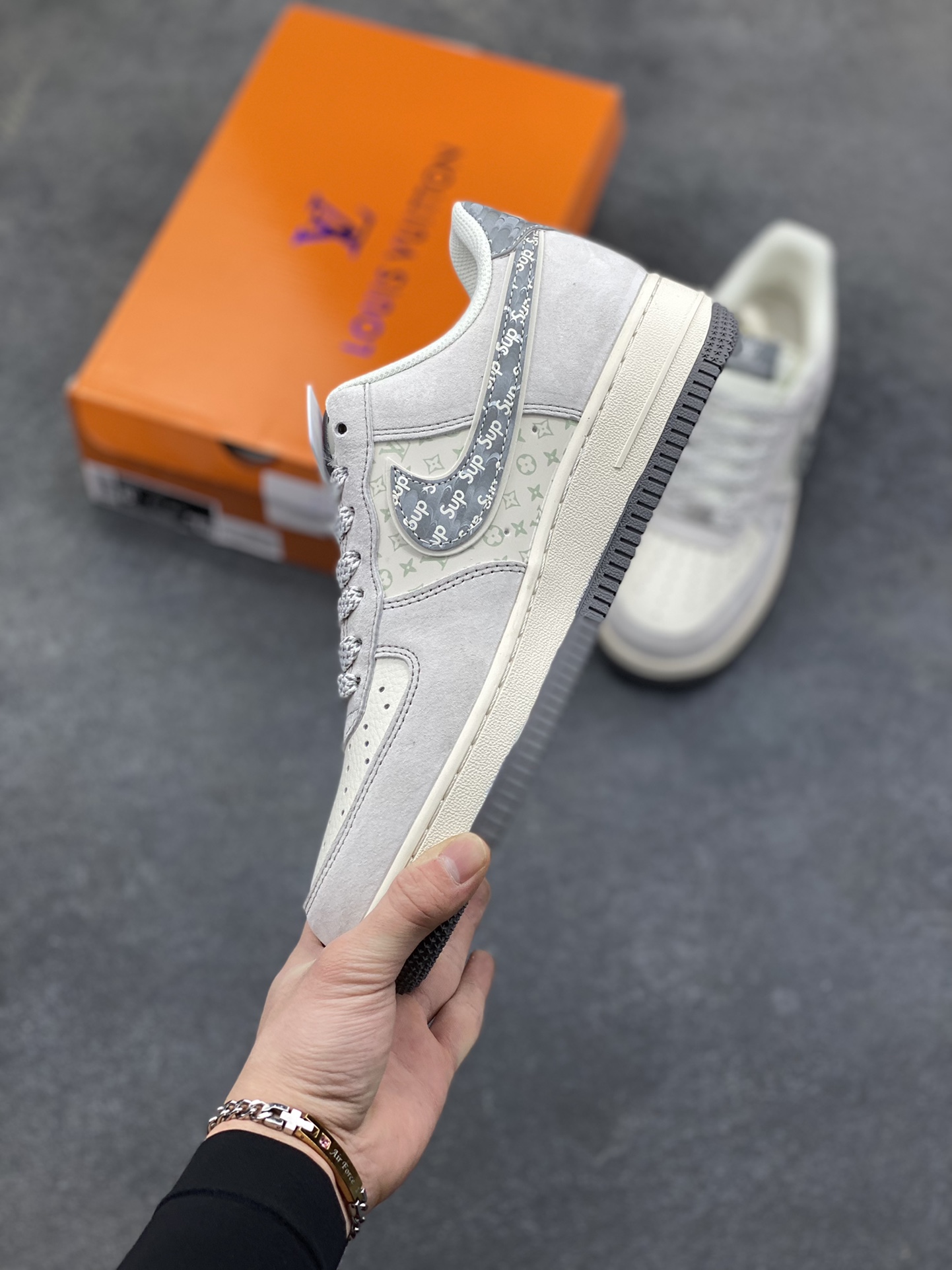 图片[3]-Air Force 1 Low x LV x Supreme 联名款｜顶奢与街头的终极融合！当Nike Air Force 1的经典轮廓，遇上Louis Vuitton的高奢基因，再叠加Supreme的街头潮范，这双Air Force 1 Low CX5050-Y48直接成为潮流圈的“王炸单品”！ 浅灰色磨砂皮革鞋身质感拉满，鞋侧Swoosh满印Supreme标志性字母，LV经典老花图案以浅绿调低调点缀，鞋身“LOUIS VUITTON”标识醒目又不张扬，三大顶流品牌的元素碰撞出极致的视觉张力。粗织鞋带搭配做旧感米白中底，再以深灰外底收尾，复古与奢华的平衡感被拿捏得恰到好处。作为经典的空军一号低帮版型，它保留了AF1标志性的气垫缓震与百搭属性，同时通过奢牌联名的细节重塑，让这双鞋既拥有日常上脚的舒适，又具备收藏级的稀缺价值。不管是搭配高街风穿搭凸显个性，还是作为潮流收藏彰显品味，这双跨界联名款都能成为造型中的绝对焦点。这双集Nike的运动底蕴、LV的奢华格调、Supreme的街头态度于一体的Air Force 1，是真正意义上跨越圈层的潮流杰作，也是硬核玩家的必入典藏！-选品中心