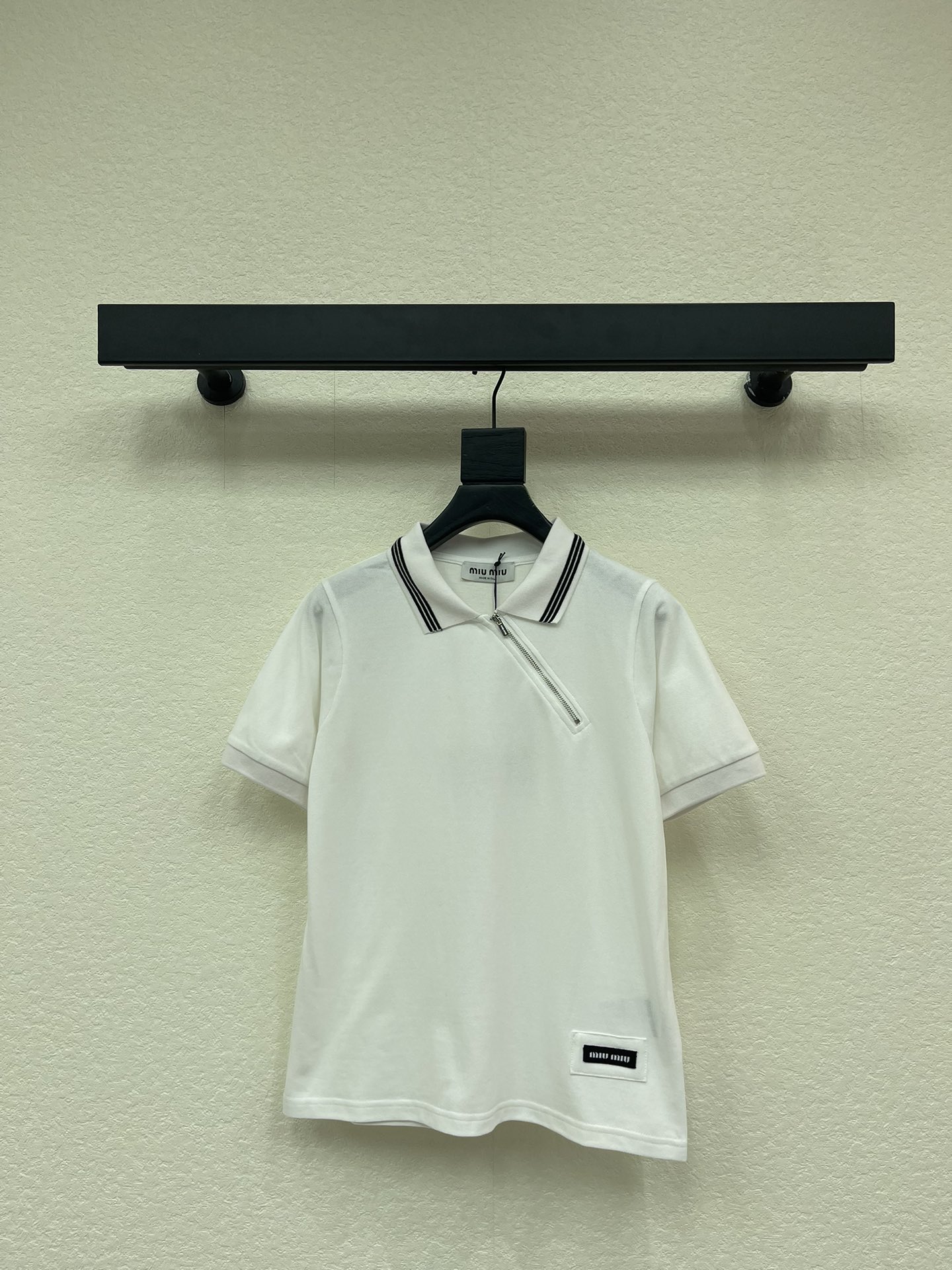 NO:666307,Miumi*26 new spring and summer style Polo collar short-sleeved shirt with diagonal zipper letter embroidery. Customized high-density pique cotton fabric. Very wide and stylish, showing sporty elegance. Charming upper body, breathable, comfortable and with a sense of luxury. Striped edge design. Three-dimensional seal embroidered letter logo embellishment on the hem. Loose cut upper body to make the body slimmer. SML,,miumiu,T-shirt, 19860909Miumi*26春夏新款 斜拉链字母刺绣Polo领短袖衫 定制高密珠地棉面料 挺阔有型 彰显运动优雅 魅力上身透气舒适又自带高级感 条纹边缘设计 衣摆立体章仔刺绣字母logo点缀 宽松剪裁上身显瘦 SML,,miumiu,T-shirt, ,Women's clothing