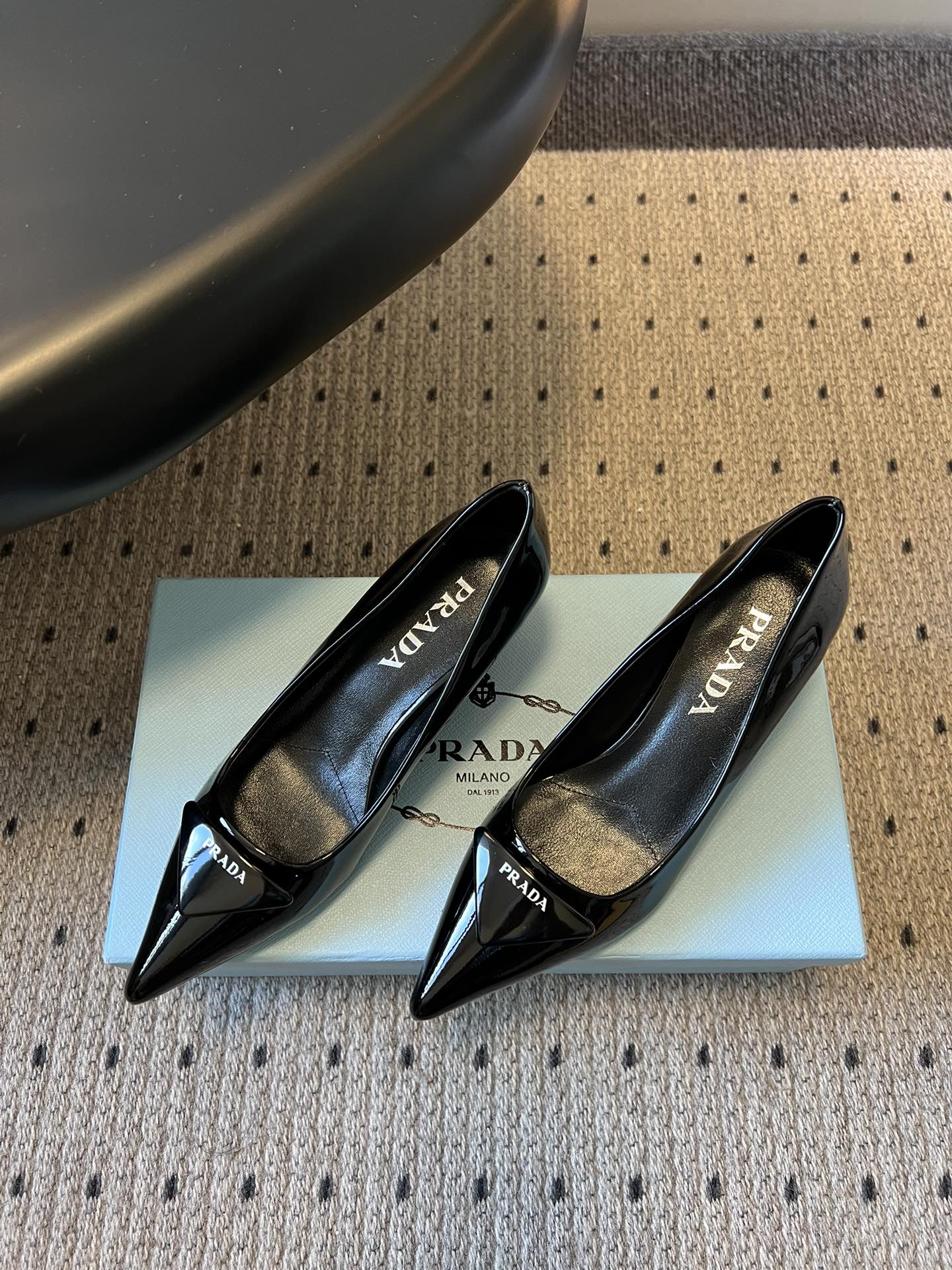Prad* 26ss经典款三角标尖头小高跟单鞋采用锐利尖头+几何三角标的组合，鞋头处的三角拼接是品牌辨识