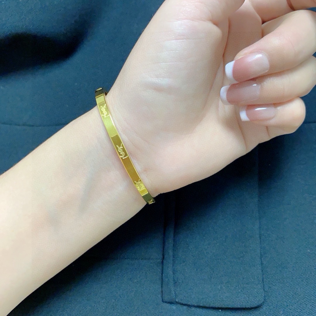 Saint Laurent Cassandre Logo Engraved Bangle bracelet gold-tone metal no accent stones 17cm inner circumference