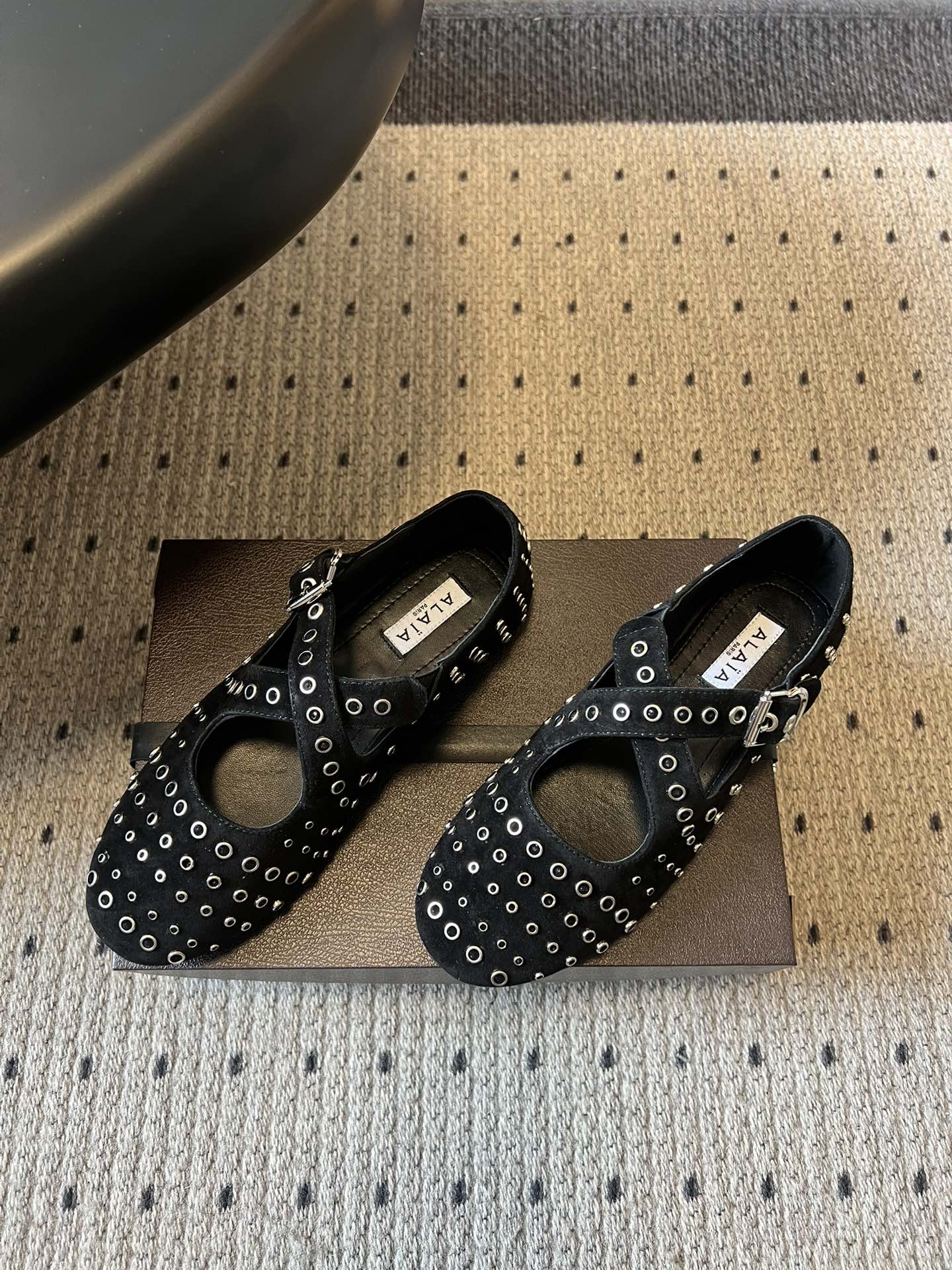 ALAÏ* 26ss 早春新款平底圆形镂空交叉绑带玛丽珍鞋单鞋鞋面采用镂空设计，形成密集的圆形孔洞纹理，