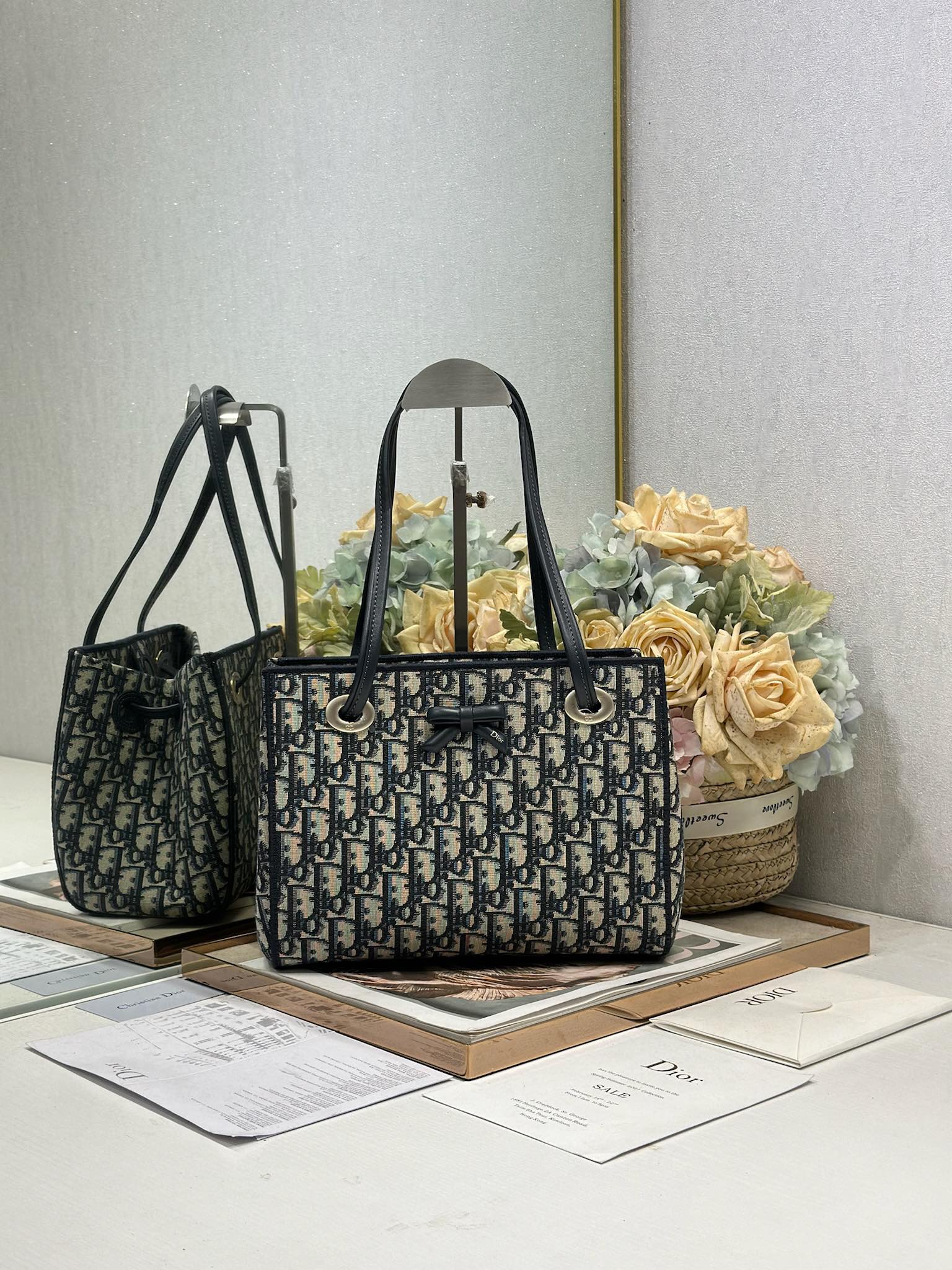 NO:770964,Dior's new small shopping bag This shopping bag was created by Jonathan Anderson for Dior. Its practical and spacious design is enhanced by a delicate bow, showing Dior's new signature details. The small style combines materials such as Oblique printed fabrics and leather trims. Its soft silhouette and clever sliding top handle make it unique. It can be carried by hand, shoulder or cross-body. Magnetic closure Dior signature leather bow on the front  Sliding top leather handle with CD logo eyelet Internal zip pocket Internal slip pocket Model 1410 Dimensions 27 x 19 x 13.5 cm (L x H x W) Holds 1 wallet, 1 mobile phone, 1 card holder, sunglasses and lipstick, Dior, dior, dior, wallets19860909Dior新款小号购物袋 这款购物袋由乔纳森·安德森 (Jonathan Anderson) 为 Dior 倾情打造,实用宽敞的设计饰以精美蝴蝶结提升格调,展现 Dior 的全新标志细节.小号款式,将 Oblique 印花面料和皮革装饰等材质巧妙结合,柔软廓形和巧妙的滑动式顶部手柄别具一格,可手提、肩背或斜挎. 磁性开合 正面饰以 Dior 标志皮革蝴蝶结 顶部滑动式皮革手柄,搭配 CD 标志孔眼 内部拉链口袋 内部插袋 型号1410 尺寸27 x 19 x 13.5 厘米（长 x 高 x 宽） 可收纳 1 个钱包、1 部手机、1 个卡夹、太阳眼镜和唇膏,迪奥,dior,dior,wallets,Bag