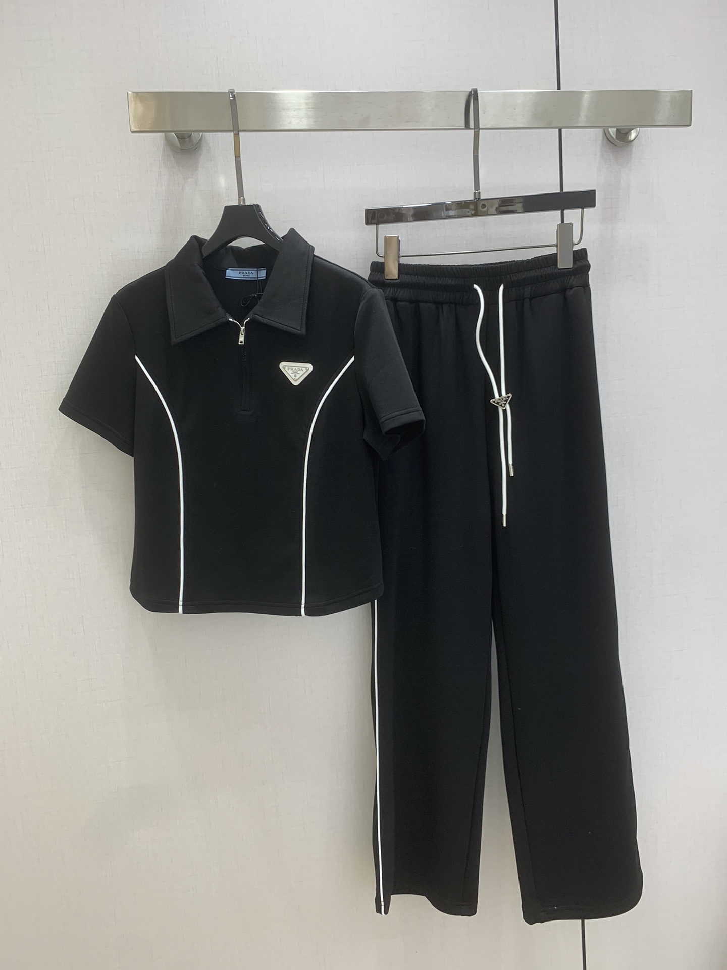 NO:751399,Highly recommended 26 early spring new style  The contrasting color splicing sports suit, with the classic triangle brand on the chest decorated with high-end air-layer fabrics, is the temperament of summer. The zipper lapel short-sleeved top is neat and slim, with a casual and sassy feel; the wide-leg pants are designed to hide the flesh and lengthen the legs, bringing a light aura when walking. The overall design is simple but not ordinary and casual, with a high-end style. Wear it out in the summer, whether it is for sports, shopping or dating, you can easily wear a sleek and slim temperament, with both comfort and style.  Two colors SML code high quality ABC, T-shirt,19860909强烈推荐 26早春新款 撞色拼接运动套装,胸前经典三角牌装饰高端空气层面料,这是夏日里的气质担当.拉链翻领短袖短款上衣利落显瘦,自带随性飒感；阔腿裤版型藏肉显腿长,走动间带起轻盈气场.整体设计简约却不普通休闲中藏着高级范儿.夏日穿它出门,无论是运动、逛街还是约会,都能轻松穿出洋气显瘦的利落气质,舒适与格调两不误 两个色 SML码 高品质ABC,,T-shirt,,Women's clothing