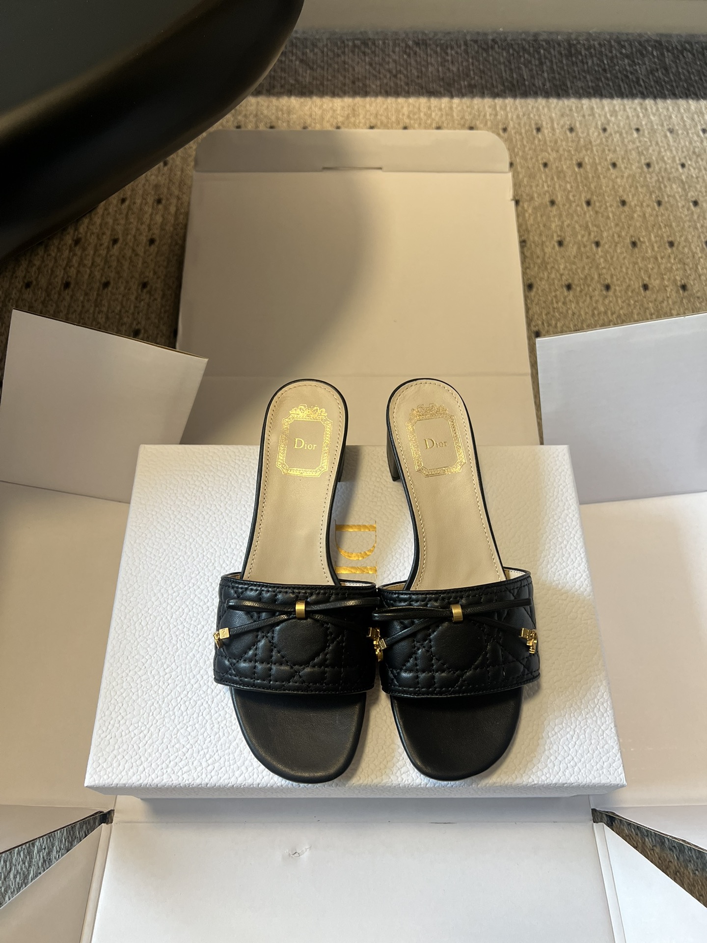 NO:784372,Dio*26ss new early spring cannage pattern bow flat low-heeled double-height sandals are essential summer shoes with a rich atmosphere. The uppers are made with Dior's iconic cannage pattern quilting technology. The soft black leather is embellished with exquisite metal ornaments and bow details. It is low-key and engraved with the brand's genes. Everything tells the story of French elegance. Square toe flat design,  It not only modifies the shape of the foot, but also takes into account the comfort of daily walking. It does not choose the shape of the foot or the outfit. The flat bottom is comfortable and elegant with low heels. Wearing it with jeans is a casual French style, and wearing a dress is gentle and elegant. Wearing suit pants can also unlock the sense of luxury in the workplace. A pair of shoes can cover N types of outfit possibilities throughout the summer. Sheepskin upper, sheepskin lining, genuine leather outsole, size 35-42 (customized sizes 40, 41, and 42 are not returnable)  Heel height 4.5cm, slippers, dior, dior, slippers, skirts, jeans, business suit, sheepskin19860909Dio*26ss早春新款藤格纹蝴蝶结平底低跟双高度凉拖 自带千金氛围感的夏日刚需鞋履,以迪奥标志性藤格纹绗缝工艺打造鞋面,柔润的黑色皮革上,点缀精致金属饰件与蝴蝶结细节,低调刻满品牌基因, 每一处都在诉说法式优雅的底蕴.方头平底设计, 既修饰脚型线条,又兼顾日常行走的舒适感,不挑脚型也不挑穿搭.平底舒适低跟优雅. 配牛仔裤是随性法式风,搭连衣裙是温柔千金感, 穿西装裤又能解锁职场高级感,一双鞋,承包整个夏天的N种穿搭可能. 鞋面羊皮 内里羊皮 大底真皮 size35-42码（40、41、42码定制不退换） 跟高4.5cm,拖鞋,dior,dior,slippers,skirts,jeans,business suit,sheepskin,Women's Shoes