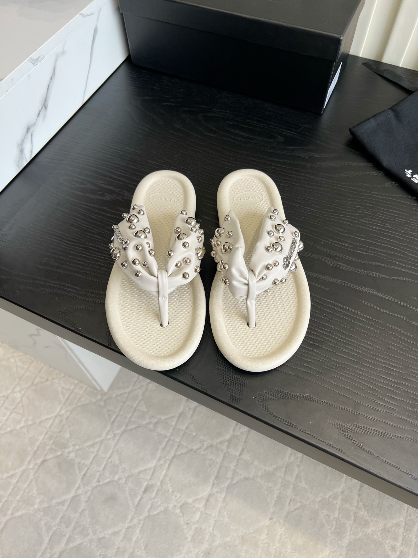 NO:904832,Isabel Marant rivet flip-flops｜A summer hot girl vibe artifact Who can resist the cool rivet flip-flops!  The pleated leather ankle straps are covered with large and small silver studs, which are low-key and recognizable. The thick padded soles are soft and comfortable to step on, and will not tire your feet after long walks. The black and white colors are versatile, black is cool and casual, and the off-white is gentle and refreshing. It is very suitable for shorts, suspenders, and casual pants. It can be worn when going shopping or on vacation at the beach. It is a must-have item for relaxed hot girls.  Size 35-39 (40 custom-made), split-toe shoes, skirts, shorts19860909Isabel Marant铆钉夹脚拖｜夏日辣妹氛围感神器 谁能拒绝自带酷感的铆钉人字拖！褶皱皮质夹脚带铺满大小银钉,低调又有辨识度,厚实软垫鞋底踩上去软糯舒适,久走不累脚. 黑白两色百搭不出错,黑色酷飒随性,米白温柔清爽.搭配短裤、吊带裙、休闲裤都超适配,出门买菜、海边度假都能穿,松弛辣妹穿搭刚需单品 尺码35-39（40定做）,分趾鞋,skirts,shorts,Women's Shoes