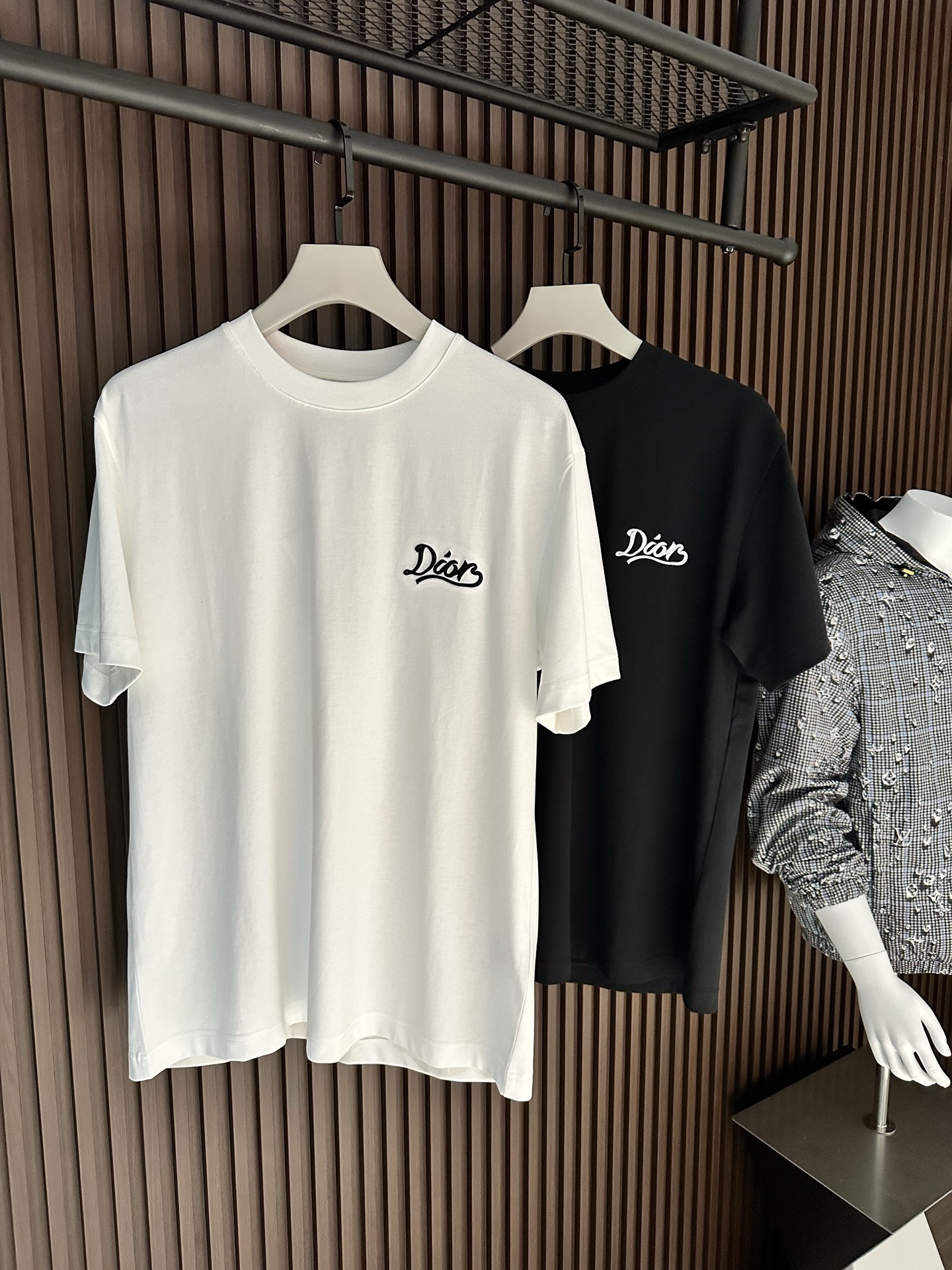 NO:903989,[New Product] 2026SS new summer product Di*r embroidered letter logo short-sleeved T-shirt has superb fashion charm and unique artistic atmosphere. The densely woven knitted cotton fabric is supplied by customers. The delicate and orderly knitting process retains the original soft texture, which is refreshing and refreshing. The texture of the fabric is the most powerful proof.  The new exquisite embroidered brand logo expresses the fusion between agility and unique ingenuity. The fine stitching technology, ribbed round neck and V collar top thread create the classic 'Forger' extension of fashion inspiration. Color: White/Black Size S/M/L/XL/2XL S Shoulder Width 44 Bust Length 66 Sleeve Length 22 M Shoulder Width 45 Bust 104 Length 68 Sleeve Length 23  L Shoulder width 46 Bust 108 Clothes length 70 Sleeve length 2419860909【新品】 2026SS夏季新品 Di*r 刺绣字母标识短袖T恤 高超的时尚魅力风范,特立独行的艺术气息. 客供密纺针织棉面料,细腻有序的针织工艺保留了最初的那份柔软质感,清肤透爽,工艺考究,织面的质感就是最有力的证明. 全新精美刺绣品牌标识表达了灵动之间的融合感,别具匠心.缝合技术精细度,罗纹圆领搭配 V 领缉面线成就经典的“锻造者”延伸时尚灵感. 颜色:白色/黑色 尺码S/M/L/XL/2XL S肩宽44胸围衣长66袖长22 M肩宽45胸围104衣长68袖长23 L肩宽46胸围108衣长70袖长24 XL肩宽47胸围112衣长72袖长25 XXL肩宽48胸围116衣长74袖长26,,T-shirt,tees，t-shirt,,Men's clothing