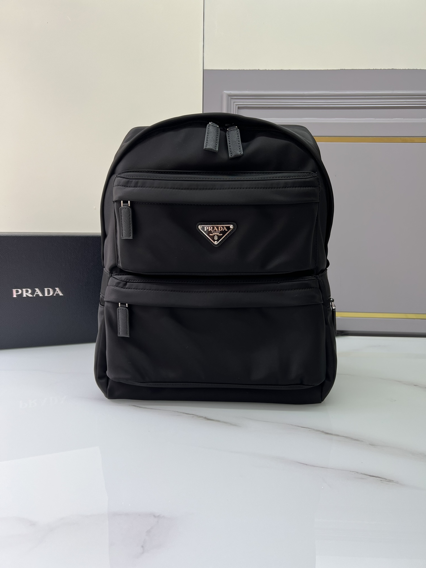 Prada launches a new backpack, 2VZ025 triangle logooriginal item, made of nylon, adjustable straps, fabric Saffiano leather handles on the back,