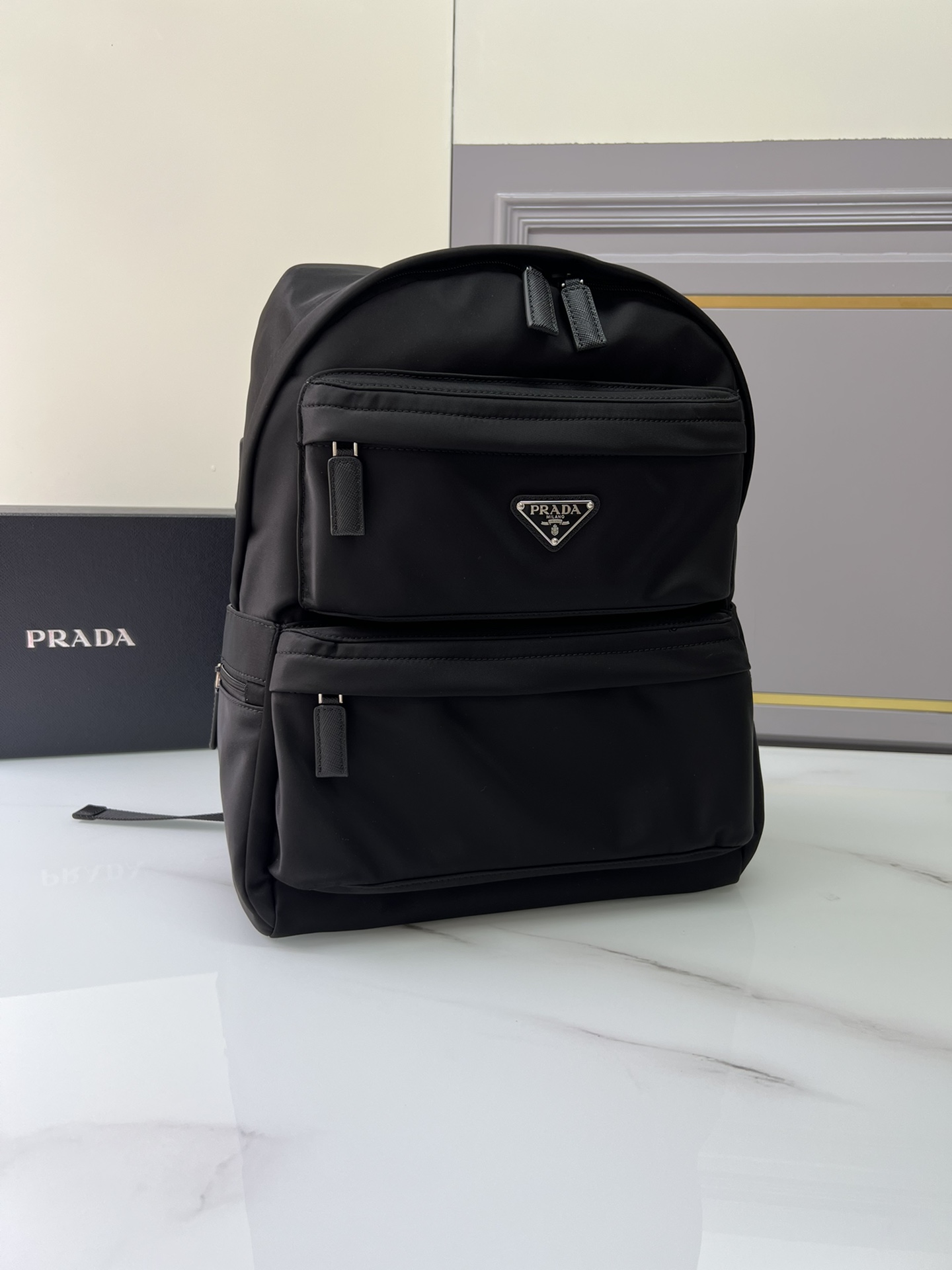Prada launches a new backpack, 2VZ025 triangle logooriginal item, made of nylon, adjustable straps, fabric Saffiano leather handles on the back,
