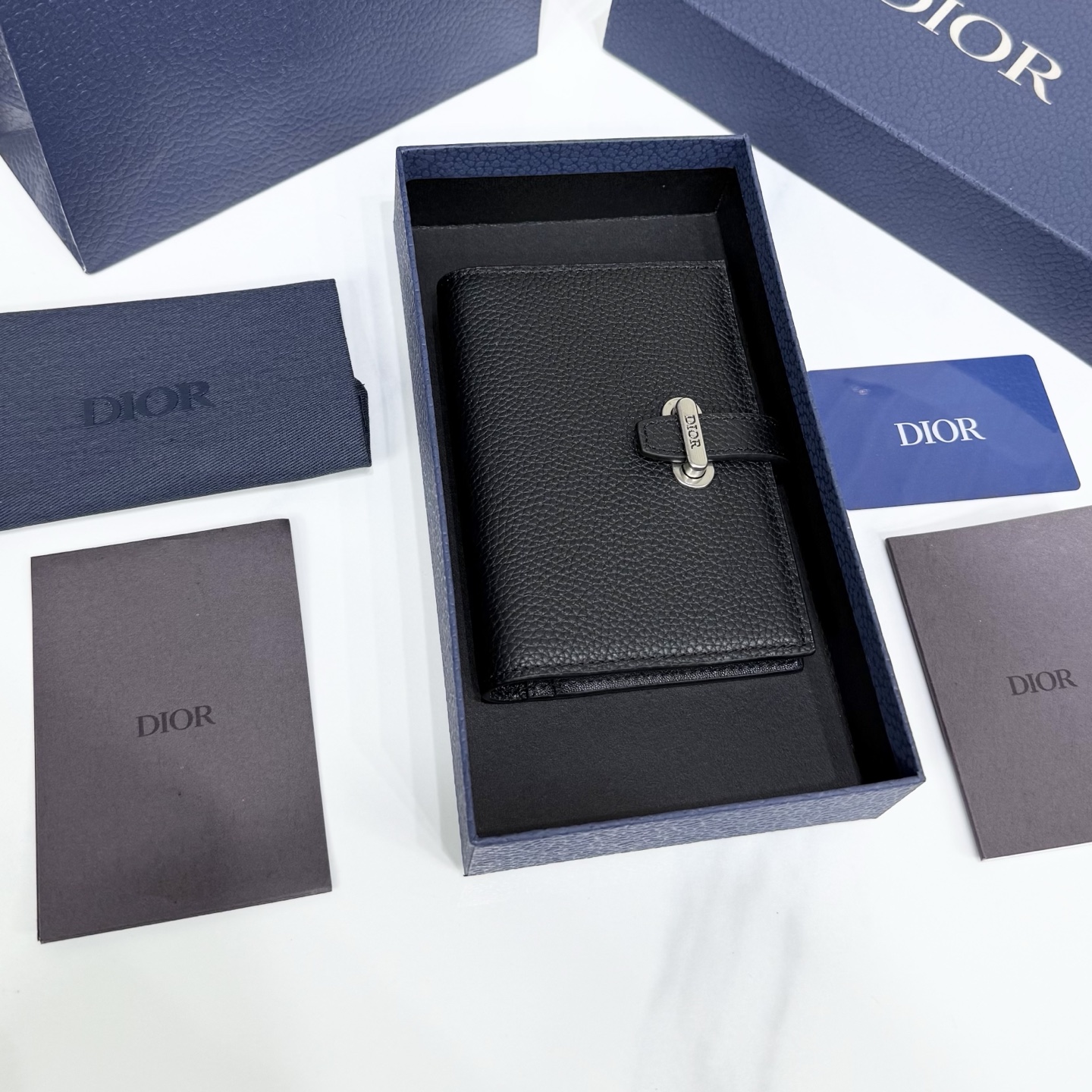 310💰市场最高版本（原单品质）正品打版

【保证里外全头层牛皮，拒绝二层皮，拒绝超纤皮】
«配盒子/礼品袋»

Dior Normandie 护照套
黑色 Dior Icons 牛皮革
编号：2LLPH021KEN_HOON
这款护照盒是 2025年冬季的新品，既实用又时尚。采用黑色 Dior Icons
小牛皮制成，采用 Dior Normandie 标志性环和带有 Dior 标志性的皮革表带，采用 Dior 工作室的非凡技艺精心制作而成。它有两个平坦的隔间、一个登机牌空间和五个卡槽。它是任何冒险的理想旅行伴侣，也可以作为大卡夹每天使用。
主要面料成分：小牛皮
小牛皮、科技面料和棉质衬里
双折模型
皮革肩带开合，复古银色饰面黄铜环饰以 Dior 标志
2个平坦隔层
5个卡槽
登机牌空间
内侧压花 Dior 标志包括保护袋
意大利/西班牙制造尺寸：10×14×1.5厘米（长×高×宽）尺寸适合护照、登机牌和信用卡
