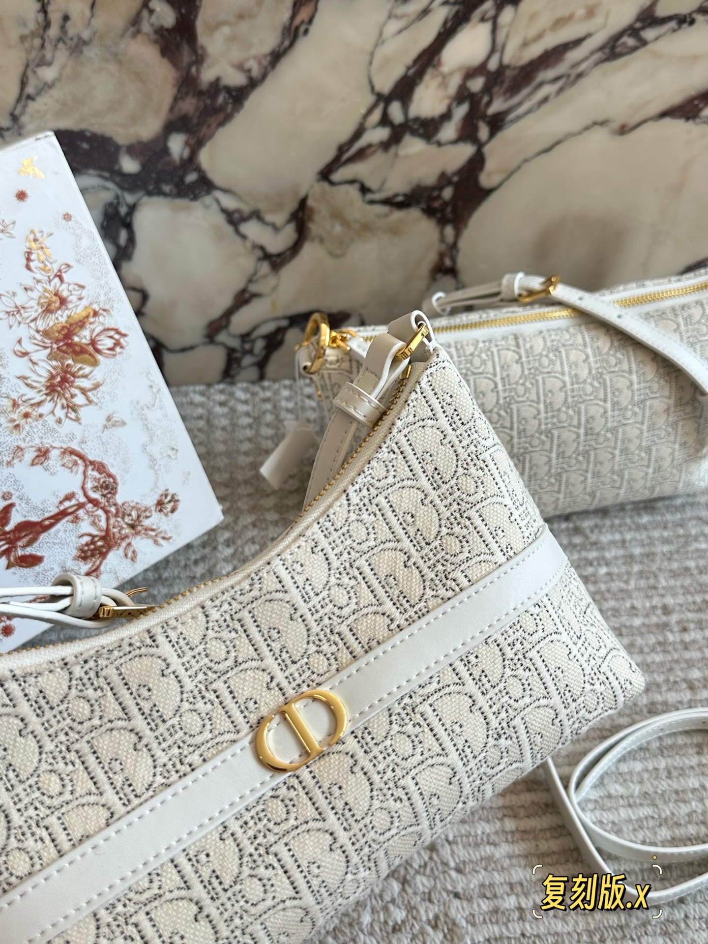 p235 
Dior。上新NEW

白花老花腋下包

这个系列很好看的 给人非常干净的感觉

腋下包，符合小包但同时容量要求不小的要求，自重非常轻，可以做到随走随拎，很方便

同系列护照夹也是极简的设计可以插三张卡24cm