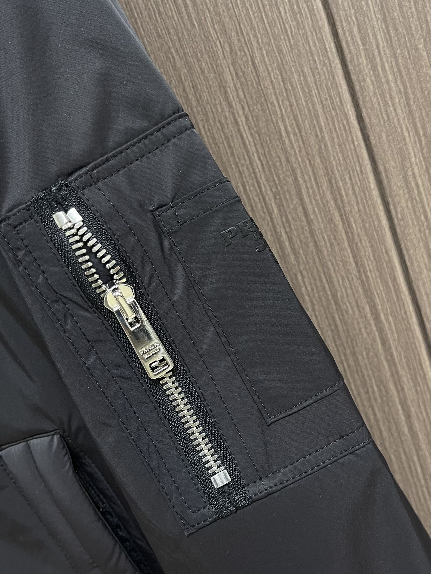 
Prada 2025SS秋季新款连帽夹克外套，胸前搭配标志性珐琅三角徽章标识，属于灵魂式点缀，夹克属于