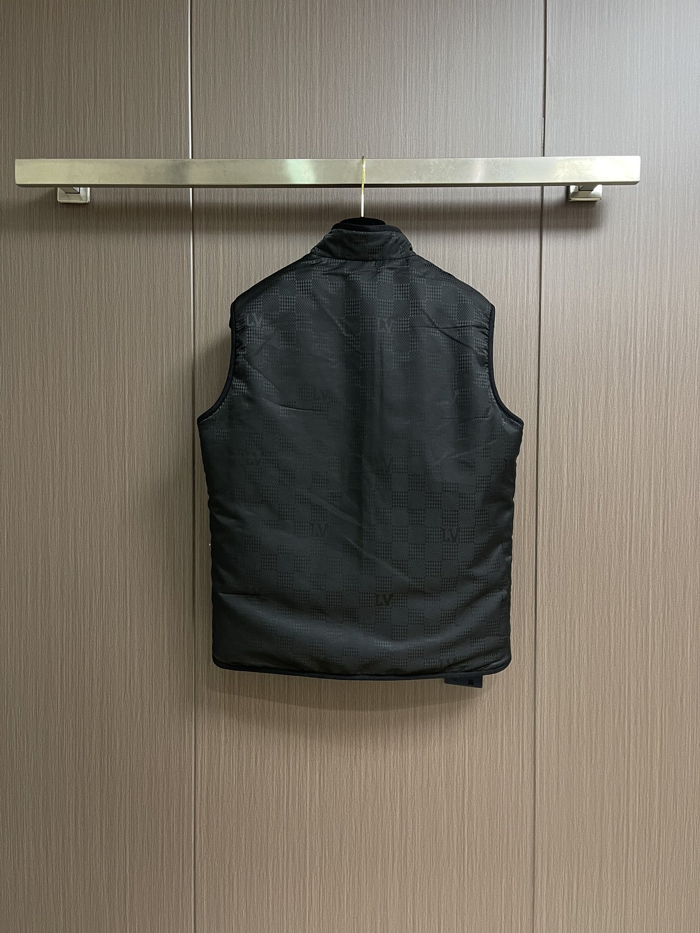 LV 双面背心，拥有轻薄衬垫，以 Monogram绗缝图案和 Damier 提花分饰两面，令换季造型流露