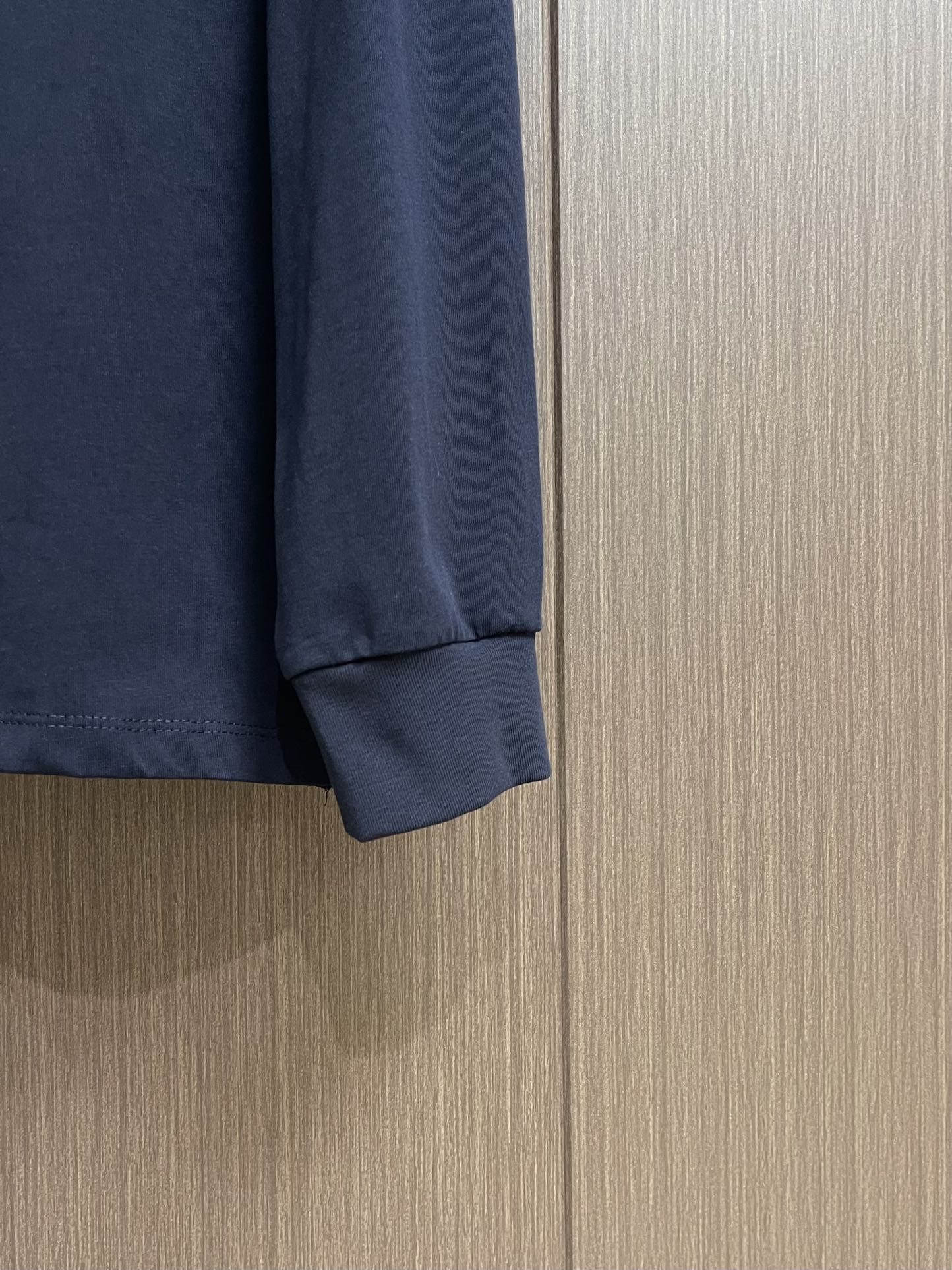 MIUMIU 2025SS圆领藏青色长袖T恤，采用高品级24支精梳棉纱线，通过「先染后织」工艺确保色彩均