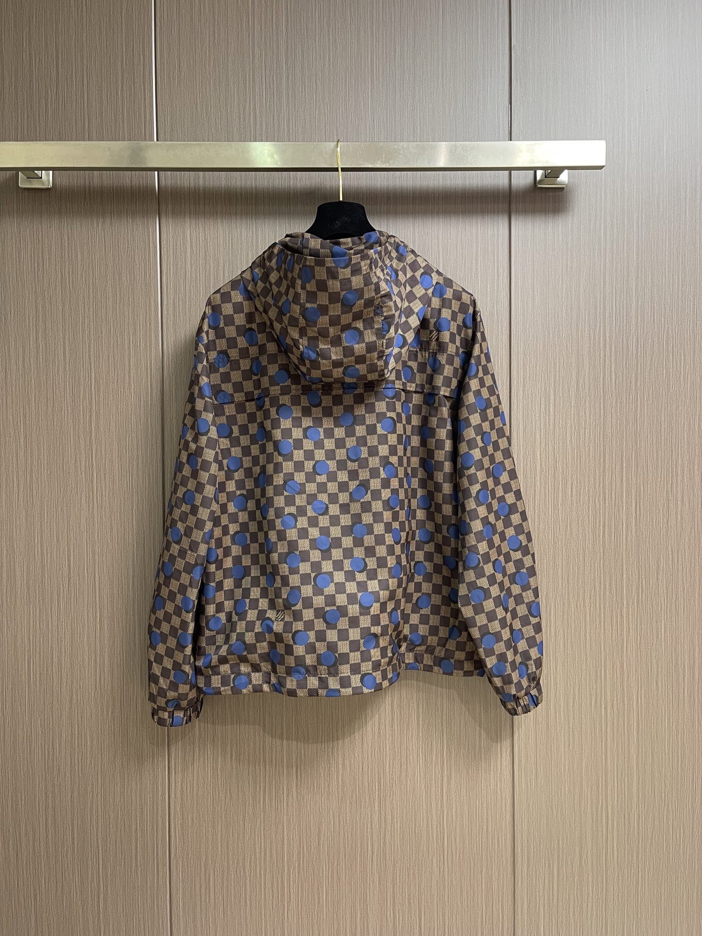 LV 波点棋盘格防风外套，本款防水防风夹克以醒目的 Damier 波尔卡圆点图案点亮夏日造型。科技面料呈