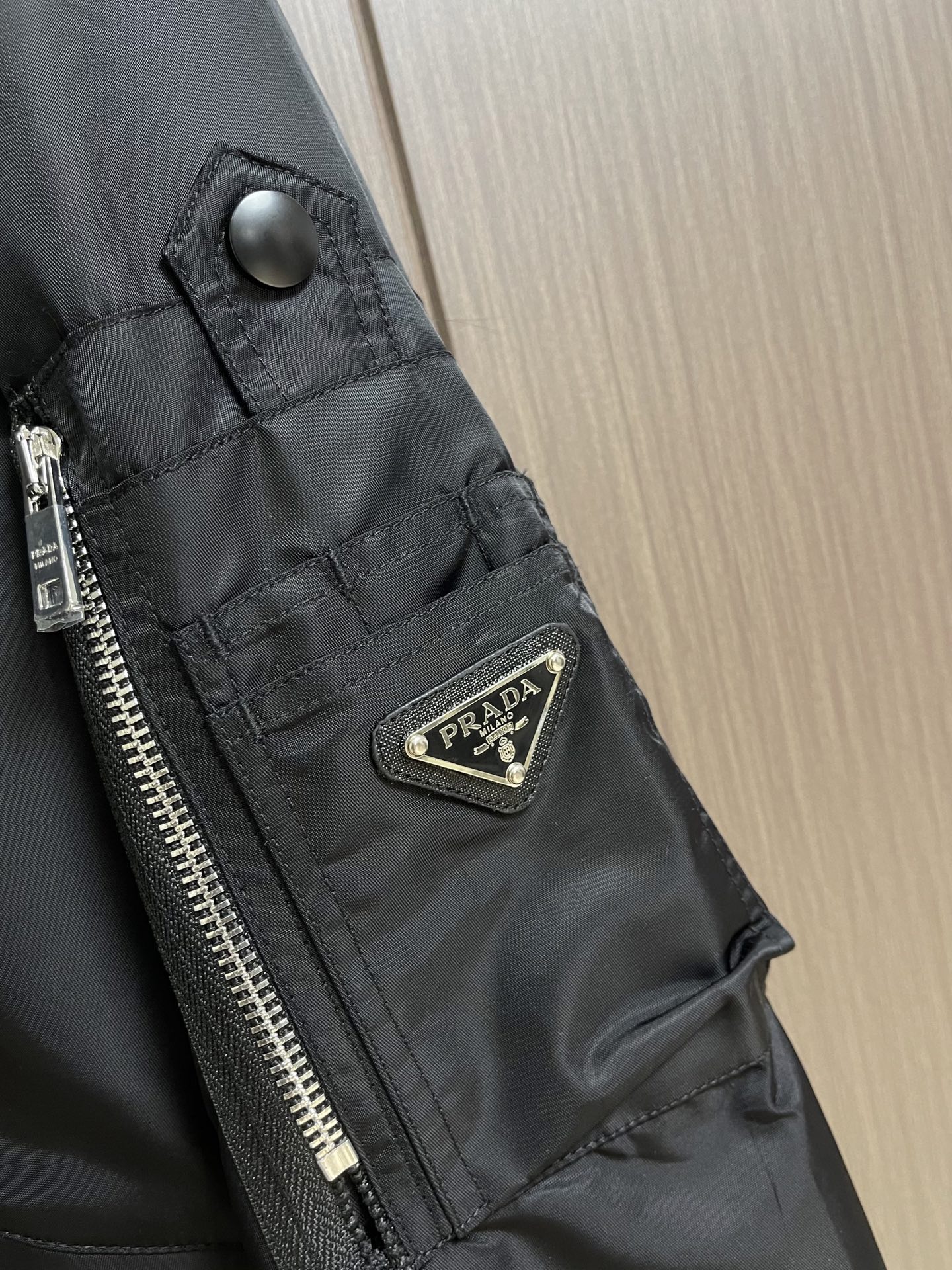 Prada，再生尼龙功能性夹克，面料采用品牌标志性的再生尼龙环保材料，与原生尼龙一样具有高强度、耐磨性和