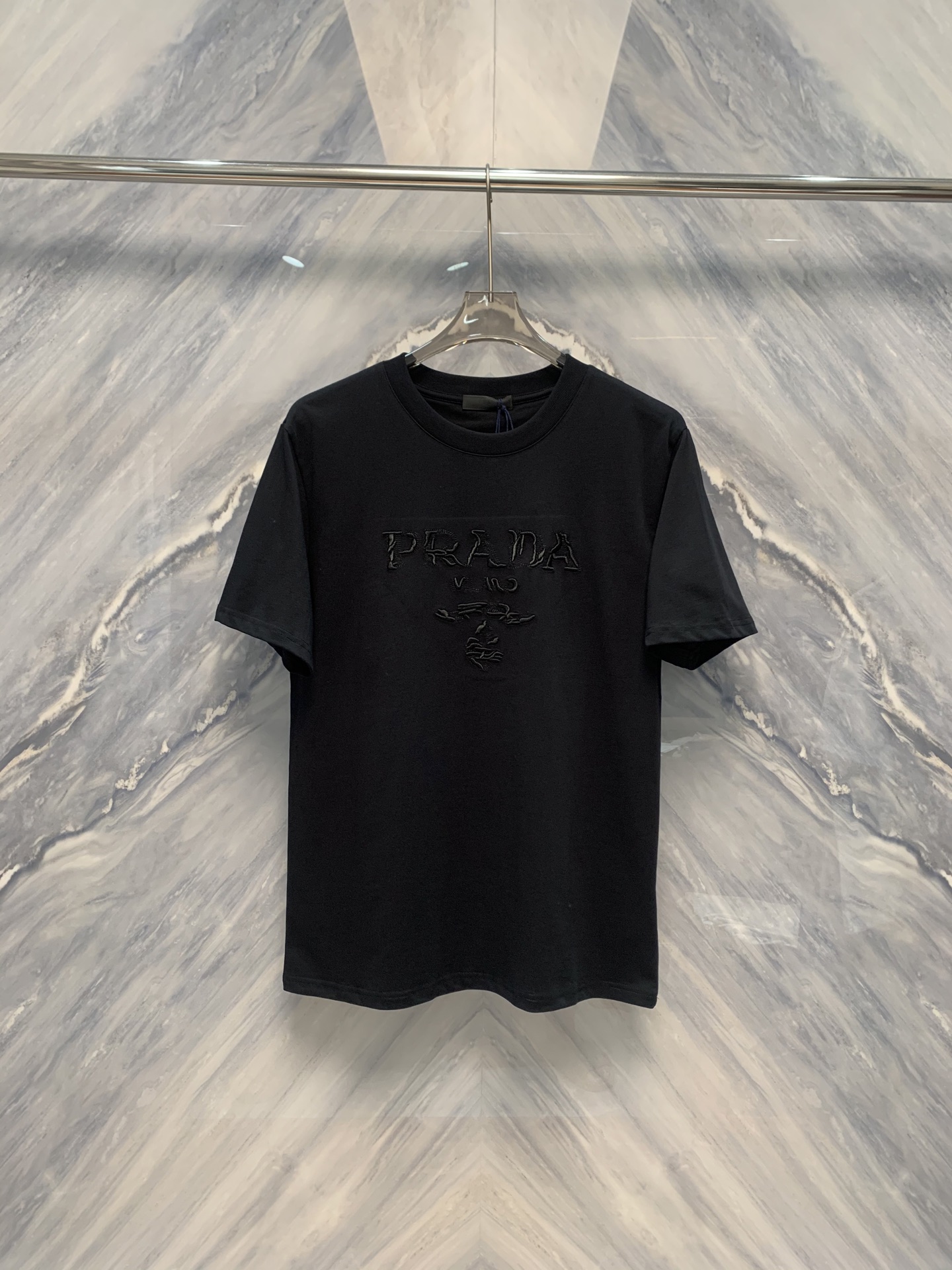 NO:419456,The original spring and summer new product orders Lada Gradient Logo Bailing Wan Needle Embroidered Cotton Round Neck Short-Sleeve T-shirt is the beauty of details. Lada Gradient Logo Bailing Wan Neck Embroidered Cotton Round Neck Short-Sleeve T-shirt is a must-have item in summer wardrobe. Its design and details reflect quality and fashion everywhere. This T-shirt is made of pure cotton, soft and breathable, bringing a comfortable touch to the skin. The classic round neck design is simple and elegant, suitable for wearing in all occasions. The overall style of the T-shirt is loose and moderate, which can well modify the figure and show a casual and comfortable style.  The most eye-catching thing is the Lada Gradient Logo Bailingda Wan Needle Embroidery on the T-shirt. This embroidery pattern is located on the chest of the T-shirt, exquisite and delicate. The gradient color processing makes the logo more three-dimensional and dynamic, as if telling the unique story of the brand. The Wan Needle Embroidery craftsmanship brings the details to the extreme, and each line is smooth and natural, fully demonstrating the exquisite skills of the craftsman. In terms of color matching, the T-shirt is based on a simple solid color and matched with a gorgeous gradient logo, which is not too ostentatious, but also highlights the wearer's personality. Whether it is matched with jeans or shorts, it can be easily controlled and shows different fashion styles. Color: Black Size: S-2XL S: Bust 102 Length 71 Shoulder width 45 Sleeves 23 M: Bust 106 Length 72 Shoulder width 46 Sleeves 24 L:  Bust 110 Clothes length 73 Shoulder width 47 Sleeve length 25 XL: Bust 114 Clothes length 74 Shoulder width 48 Sleeve length 26 XXL: Bust 118 Clothes length 75 Shoulder width 49 Sleeve length 27, shorts, jeans, T-shirt,tees, t-shirt,alexander wang19860909春夏新品原厂订单拉达渐变Logo百灵达万针刺绣棉质圆领短袖T恤细节之美,拉达渐变Logo百灵达万针刺绣棉质圆领短袖T恤是夏季衣橱的必备单品,它的设计和细节处处体现着品质与时尚. 这款T恤采用纯棉材质,柔软透气,给肌肤带来舒适的触感.经典的圆领设计,简洁大方,适合各种场合穿着.T恤的整体版型宽松适中,能够很好地修饰身材,展现出随性自在的风格. 最引人注目的是T恤上的拉达渐变Logo百灵达万针刺绣.这个刺绣图案位于T恤的胸前,精致细腻.渐变的色彩处理使得Logo更具立体感和动态美,仿佛在诉说着品牌的独特故事.万针刺绣工艺更是将细节做到了极致,每一根线条都流畅自然,充分展示了匠人的精湛技艺.在色彩搭配上,T恤以简约的纯色为基础,搭配上绚丽的渐变Logo,既不会过于张扬,又能凸显出穿着者的个性.无论是搭配牛仔裤、短裤,都能轻松驾驭,展现出不同的时尚风格. 颜色:黑色 尺寸:S-2XL S: 胸围102 衣长71 肩宽45 袖长23  M: 胸围106 衣长72 肩宽46 袖长24 L: 胸围110 衣长73 肩宽47 袖长25 XL: 胸围114 衣长74 肩宽48 袖长26 XXL: 胸围118 衣长75 肩宽49 袖长27,,shorts,jeans,T-shirt,tees，t-shirt,alexander wang,Men's clothing