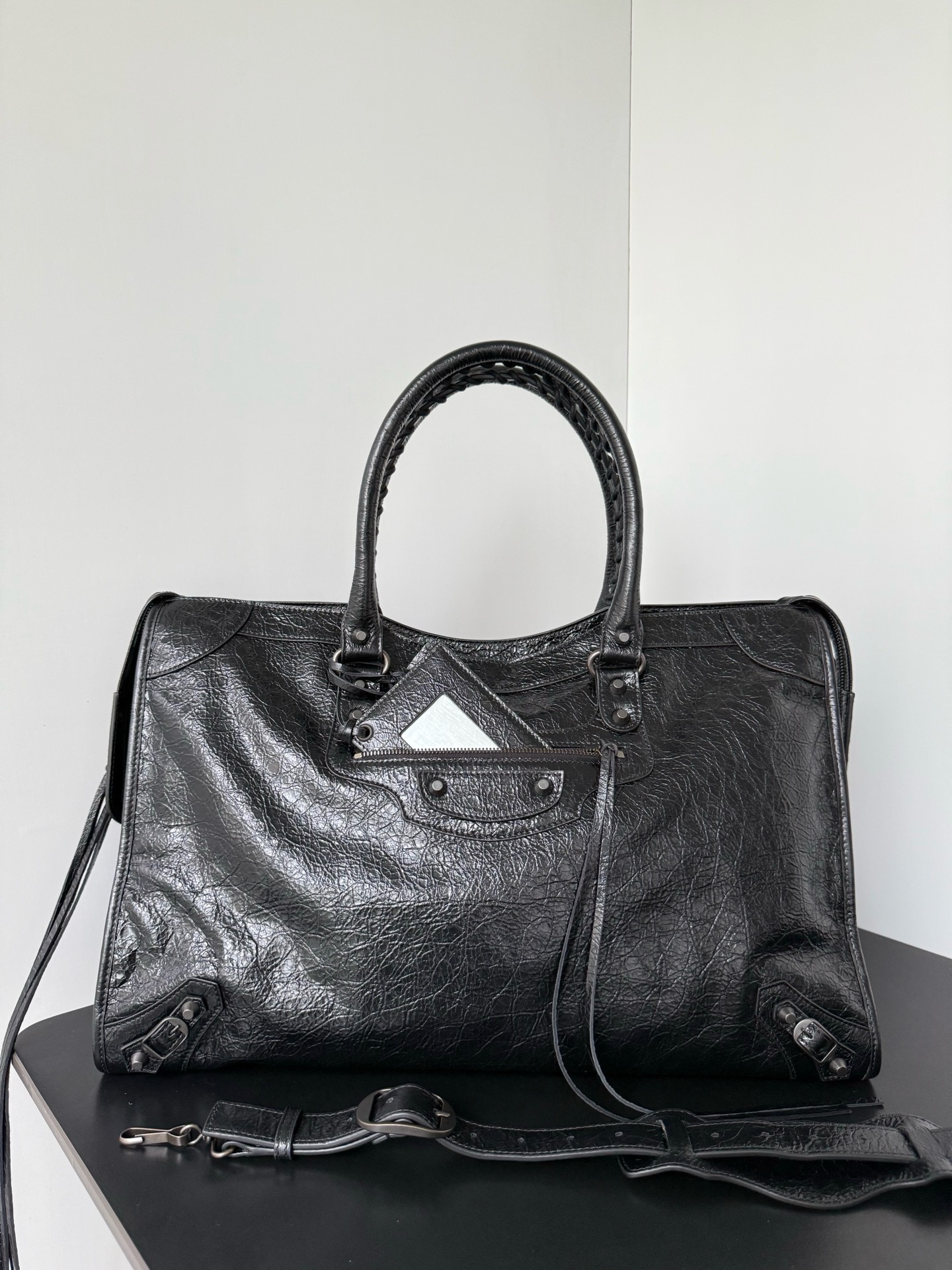 NO:894850,*  It was famous for its extremely modern style when it first came out. With its casual and natural elegance, it quickly captured the favor of the fashion industry and celebrity circles, and became a popular classic of the times. After years of reinterpretation, this new iteration of the classic handbag is the symbol of the classic style.  All the unique design details are retained, including the hand-woven cotton rope-woven leather rolled handles, detachable shoulder straps with shoulder pads, leather-edged rectangular hanging mirrors, etc. The body of the bag also retains the brand's highly recognizable rivet-shaped studs, leather lace-up zipper pullers and small decorative buckles.  Dimensions length 46 x height 29 x width 16.8 cm Model: 865765, Balenciaga, balenciaga19860909* 初次问世便以极繁摩登的风格闻名凭借随性天成的优雅格调迅速俘获时尚界与名流圈层的青睐,一跃成为时代经典爆款历经多年焕新演绎,这款经典手袋的全新迭代版本经典款式的标志性设计细节得以悉数保留手工棉绳编织的皮革卷形提手、带肩垫的可拆卸肩带、皮革包边的长方形悬挂镜等,包身亦保留了品牌辨识度极高的铆钉形饰钉、皮革系带拉链头与小巧装饰扣 尺寸长46 x 高29 x 宽16.8厘米 型号: 865765,巴黎世家,balenciaga,Bag