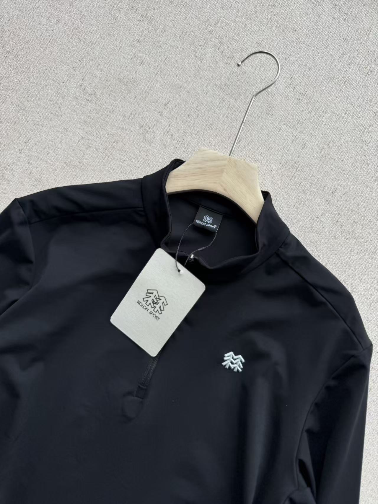 💰215（细节图）
KOLON SPORT可隆吸湿速干TS-Functional男半拉链长袖速干衣
这款产品是KOLON SPORT品牌下非常经典和实用的一款功能型内衣/中层衣，非常适合户外运动和日常穿着。

产品核心特点解析

1. 品名解读：TS-Functional

· TS 通常指的是 “Trekking & Sports” 或 “Technical Sports”，意为“徒步与运动”或“专业运动”，表明其专为户外活动设计。
· Functional 即“功能的”，强调它并非普通棉质衣物，而是具备特殊功能性。

2. 核心科技：吸湿速干 (Moisture-Wicking & Quick-Drying)

· 面料：通常采用聚酯纤维（Polyester） 或特殊的功能性化纤面料。
· 工作原理：通过特殊的纤维结构或织法，将皮肤表面的汗液迅速吸收并扩散到面料外层，增大蒸发面积，从而实现快速蒸发干燥。
· 好处：在运动时保持身体干爽，避免因汗水滞留而导致的湿冷感和不适，有效防止感冒，提升运动舒适度。

3. 设计亮点：半拉链（1/4 Zip）

· 通风调节：半拉链设计是这款衣服的一大亮点。在运动强度大、体热升高时，可以轻松拉开拉链，快速散热，调节体温。
· 便于穿脱：相比套头款式，半拉链设计穿脱更加方便。
· 有型时尚：半拉链设计比全拉链更显利落，比无领款式更有层次感，兼具功能性与时尚感，日常外穿也很好看。

4. 版型与舒适度

· 立体剪裁：通常采用符合人体工学的立体剪裁，在肩部、肘部等关节处留有活动余量，确保运动时不受束缚。
· 扁平缝骨（Flatlock Seam）：内部的接缝处多采用平滑的压胶或扁平缝制工艺，减少与皮肤的摩擦，避免长时间运动导致的摩擦不适，尤其适合背包徒步时穿着。
· 轻量透气：面料本身非常轻薄，收纳体积小，重量轻，透气性好。

适用场景

· 户外运动：徒步、登山、骑行、露营、跑步等各类活动的基础层（Base Layer） 或 中层（Mid Layer）。
· 日常休闲：春秋季节的日常外套，或冬季的内搭衣物。
· 健身房训练：作为健身时的运动上衣，保持干爽。
· 旅行：轻便易干，非常适合旅行时携带。
颜色:黑色/灰色
尺码:M-XXL
          M      L   	XL   	2XL
衣长	68.5	70.5	72.5	74.5
胸围	52	    54	   56    58
肩宽	45	   46.5 	48  	49.5
袖长	63	    64   	65	   66