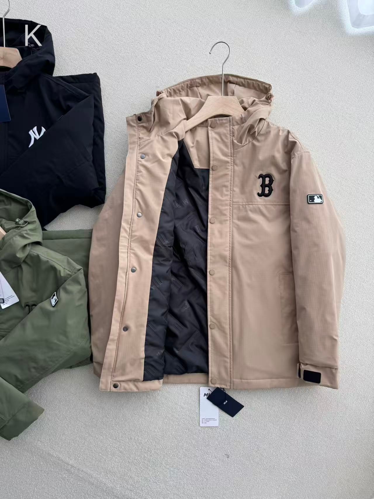 💰175
 MLB韩版2025新款洋基队NY连帽开衫落肩外套男女情侣同款冲锋衣棉服，专柜同款 1:1完美复刻，宽松款，做过预缩，抛干，手感细腻舒适，斜纹格子防水面料 专柜最新款，拉链开模定制，胸前立体刺绣logo，绝对独家定制，冬季时节的拉链外套当真是最最实用而又百搭的款式，必须是人手一件，无论是明星还是网红还是时尚达人你都可以看到它的身影。连帽开衫卫衣最能体现层次感，超级好搭配，无惧年龄挑战的爆款神器，质感十足时尚感满满，好东西值得拥有！
颜色: 黑色  卡其  绿色
尺码: S-2XL 
