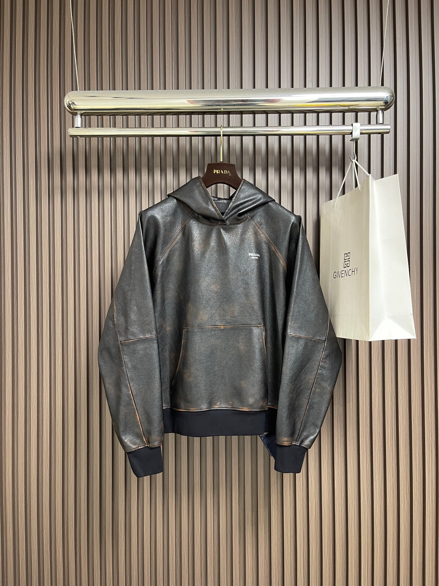 NO:600140,Prada distressed hooded raglan leather jacket. Customized Italian geological layered double-focal high-quality leather. The texture is soft and tough. The texture is natural. It is as deep as midnight black and as mellow as aged brown. The gradient colors blend naturally and resemble the traces engraved by time. The shining Prada logo embellishes the chest, which is a concrete presentation of the brand soul. Every transition of color is like the delicate brushstrokes of a painter. From a distance, it is restrained minimalism.  A closer look is a carnival of violent details. The hooded element injects a touch of casualness into the tough leather jacket. It blooms proudly as a work of art. It has become a leader in fashion trends. The imported material leather surface is printed and embroidered. Based on heat transfer technology, the metal coating of the imported anodized aluminum foil is peeled off and permanently attached to the surface of the base material through high-temperature pressure. It is strong and beautiful. The hand-made ancient rubbing method is used to wipe and treat specific parts. Up to 37 color rubbing processes achieve a local gradient effect and create a unique texture pattern.  The workmanship is extremely complex, time-consuming and labor-intensive, and manual gluing is applied to fix the strands. Physical reinforcement technology to fix the seams of the cut pieces through precise point gluing. Manual gluing work. Wave-shaped glue lines are formed along the warp and weft of the cut pieces. Heavy washing uses special solutions to remove stains and slight fading. Fading is faded through strong washing.  Make the color more uniform. The overall wiring is straight and delicate, the fabric is comfortable and soft, the color is consistent and there is no color difference. It can be matched with the same style to create a fashionable look and control various occasions. Customized accessories, complete with three standards, same style for men and women!  Size 46-52,,prada,jackets & coats,leather jacket,hats,alexander wang19860909Prada 做旧连帽插肩皮衣外套 定制意大利地质层积纹双焦优质皮革 质感柔软且坚韧 纹理自然 深邃如子夜的黑 醇厚如陈酿的棕 渐变色调自然交融 似岁月镌刻的痕迹 那熠熠生辉的Prada徽标点缀于胸前 是品牌灵魂的具象化呈现 每一道色泽的过渡都如同画家笔下细腻的笔触 远观是克制的极简主义 近赏是暴烈的细节狂欢 连帽元素为硬朗的皮衣注入一丝随性 以艺术品的姿态傲然绽放 成为时尚潮流的引领者,进口材料皮面印绣 基于热压转移技术 通过高温加压使进口电化铝箔的金属涂层剥离并永久附着于基材表面 牢固结实 美观工,纯手工古法作旧擦重位 纯手工擦拭处理特定部位 高达37道擦色工序达到局部渐变的效果 制造出独有纹理图案 做工极其复杂 耗时耗力,手工刷胶固定股位 通过精准点位施胶固定裁片接缝的物理加固技术 手工施胶作业 沿裁片经纬纱走向形成波浪状胶线,重度孝洗 通过特制溶液 去除污渍且轻微的褪色 通过强烈的洗涤方式来褪色 使其颜色更为均匀.整体走线平直细腻,面料舒适柔软,颜色一致无色差能与同款搭配营造时尚造型,驾驭各种场合,定制辅料,三标齐全,男女同款！尺码46-52,,prada,jackets & coats,leather jacket,hats,alexander wang,Men's clothing