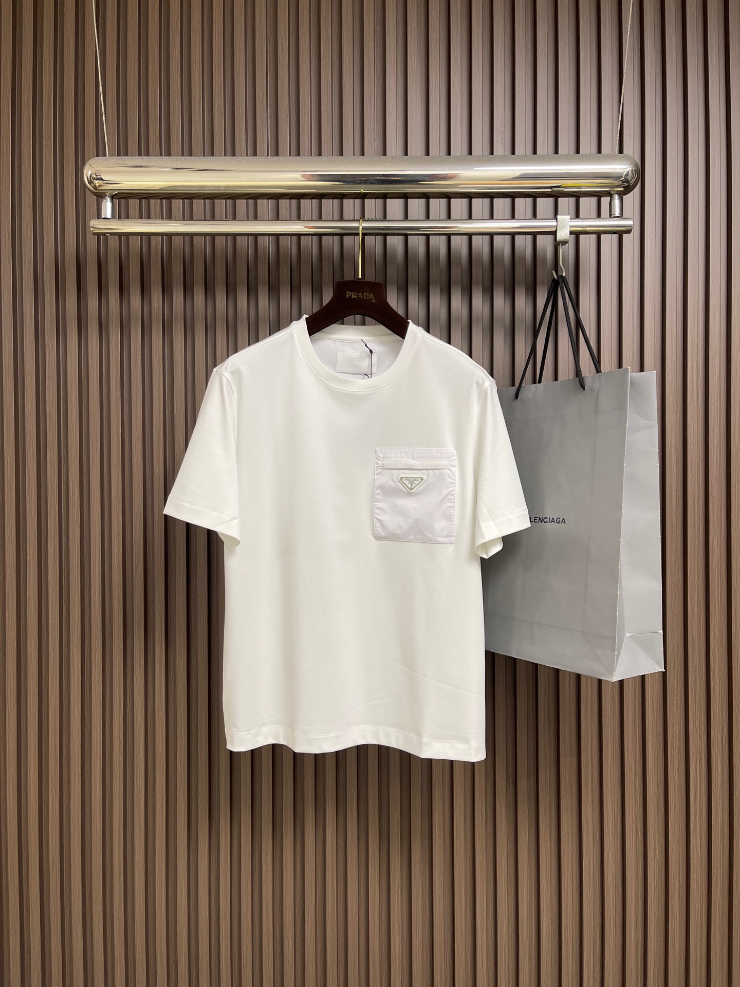 NO:703458,PRADA 2026Ss triangular logo zipper pocket short-sleeved T-shirt. The fabric is made of 50-count double-sided technical cotton. The fabric is made of long yarn refined cotton. The chest pocket fabric is made of 60-count natural mercerized nylon fabric. The fabric cost is very high. Laser positioning cutting fabric loss is very wasteful. The overall routing is straight and delicate. The fabric is comfortable and soft. The color is consistent and has no color difference. It can be matched with the same style to create a fashionable look. It has three labels and is the same for men and women!  Size 48-56 Size 48 bust 106 Shoulder width 49.3 Center back length 66 Size 50 bust 110 Shoulder width 50.5 Center back length 68 Size 52 chest 114 Shoulder width 51.7 Center back length 70 Size 54 chest 118 Shoulder width 52.9 Center back length 72 Size 56 chest 122 Shoulder width 54.1  Back center length 74,,prada,T-shirt,tees,t-shirt,19860909PRADA 2026Ss三角标拉链口袋短袖T恤,面料采用50支双面科技棉,该款面料采用长纱精棉定织成而,胸前口袋面料采用60支天然丝光尼龙面料,面料成本非常之高,激光定位裁剪面料损耗浪费非常大.整体走线平直细腻 面料舒适柔软 颜色一致无色差 能与同款搭配营造时尚造型,三标齐全,男女同款！尺码48-56 48码胸围106 肩宽49.3 后中长66 50码胸围110 肩宽50.5 后中长68 52码胸围114 肩宽51.7 后中长70 54码胸围118 肩宽52.9 后中长72 56码胸围122 肩宽54.1 后中长74,,prada,T-shirt,tees，t-shirt,,Men's clothing