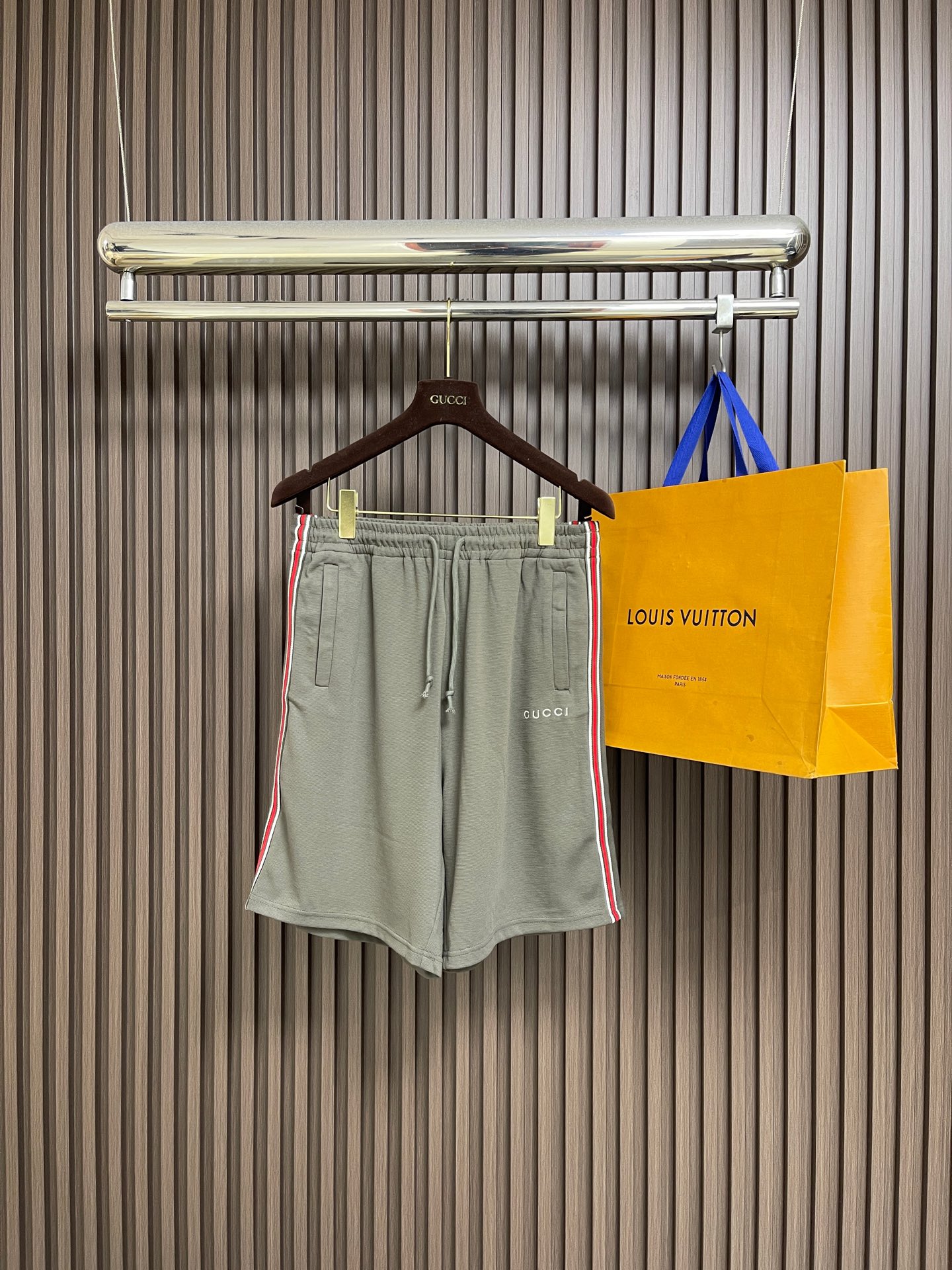 NO:759331,Tops shorts P  Trimmed webbing embroidered short-sleeved shirt and shorts suit, made of imported heavyweight cotton knitted fabric, pre-shrunk, soft and skin-friendly, breathable and not stuffy, and has excellent drape and wrinkle resistance, ensuring the quality and wearing comfort of the suit; it adopts a classic lapel design, and the front placket is decorated with the brand's iconic red and white webbing, with metal button closure, neat and stylish, and both  Casual and recognizable; both the body and shorts are embroidered with the same color brand logo, with fine and full stitching, showing a low-key three-dimensional layering on the gray fabric, breaking the monotony of solid colors and adding a sense of detailed design; it can be controlled by all body shapes, easily creating a casual and advanced daily wear style. Sizes S-XL, shorts, shirts, T-shirt,19860909上衣 短裤P 饰边织带刺绣短袖衬衫短裤套装,采用进口重磅棉质针织面料,经过预缩水处理,质地柔软亲肤,透气不闷汗,同时具备出色的垂坠感与抗皱性,保证了套装的品质与穿着舒适度；采用经典翻领设计,前襟采用品牌标志性的红白织带装饰,搭配金属纽扣开合,利落有型,兼具休闲感与辨识度；衣身与短裤均采用同色刺绣品牌标识,针脚细腻饱满,在灰色面料上呈现出低调的立体层次,打破纯色单调感,增添了细节设计感；各类身形皆能驾驭,轻松打造随性高级的日常穿搭风格.尺码S-XL,,shorts,shirts,T-shirt,,Men's clothing